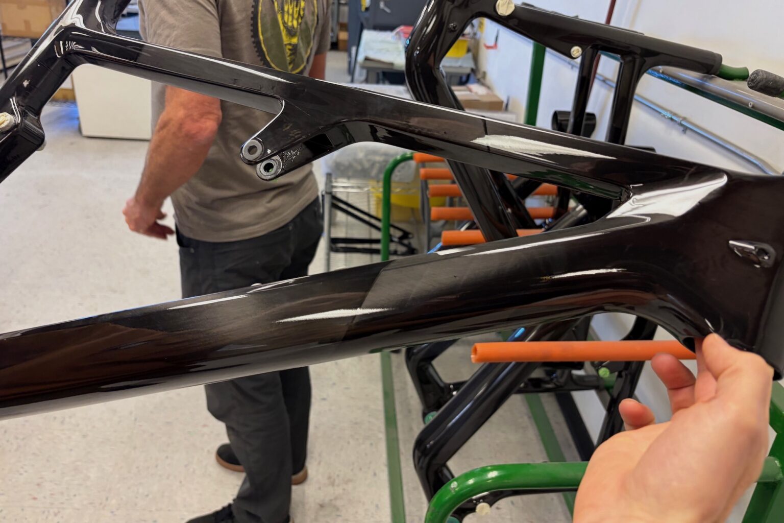 holding a freshly painted Ripley SL bike frame after getting its clear coat.