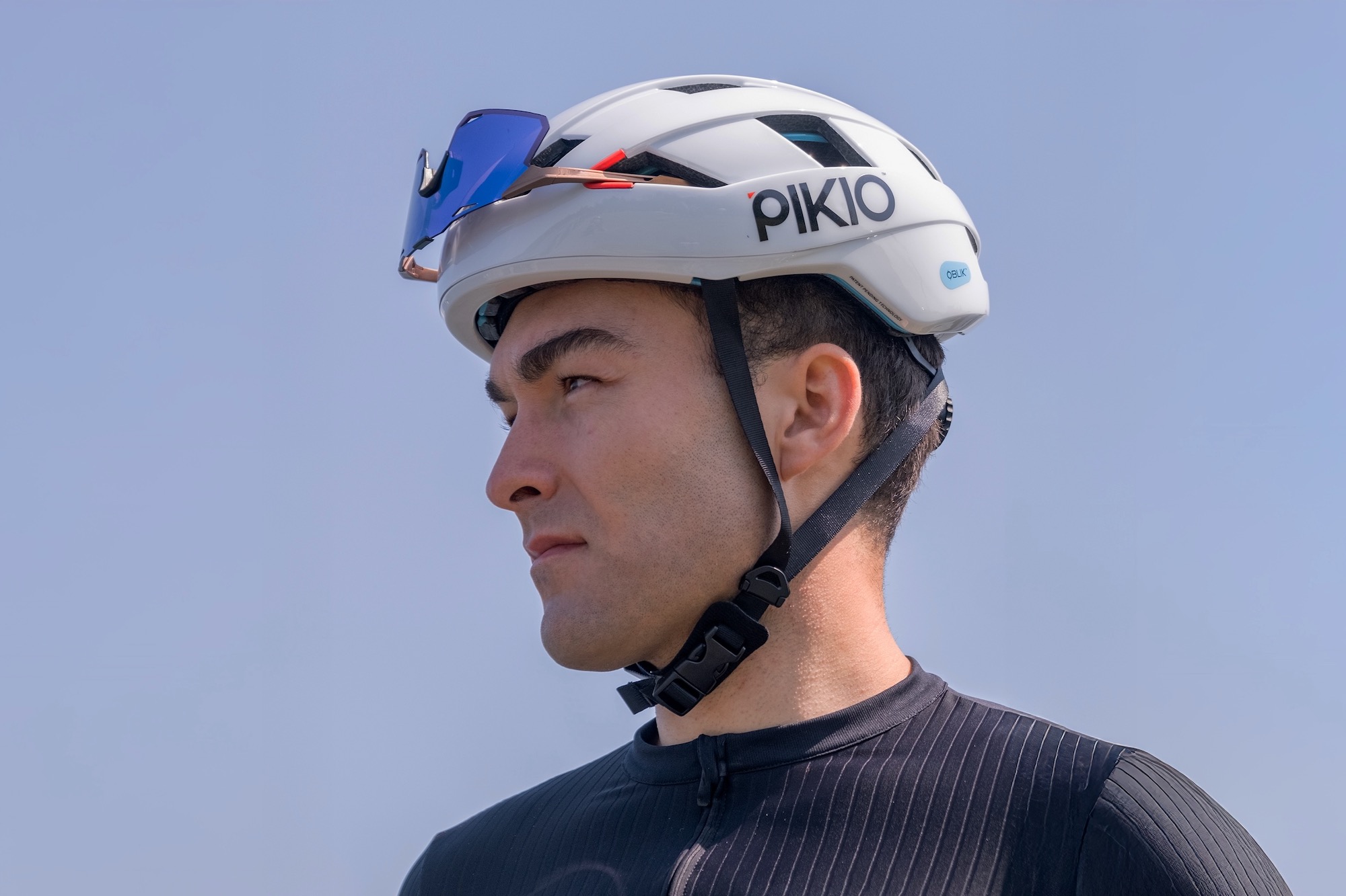 a man wearing the new PIKIO Si helmet with sunglasses stored in the sunglasses dock