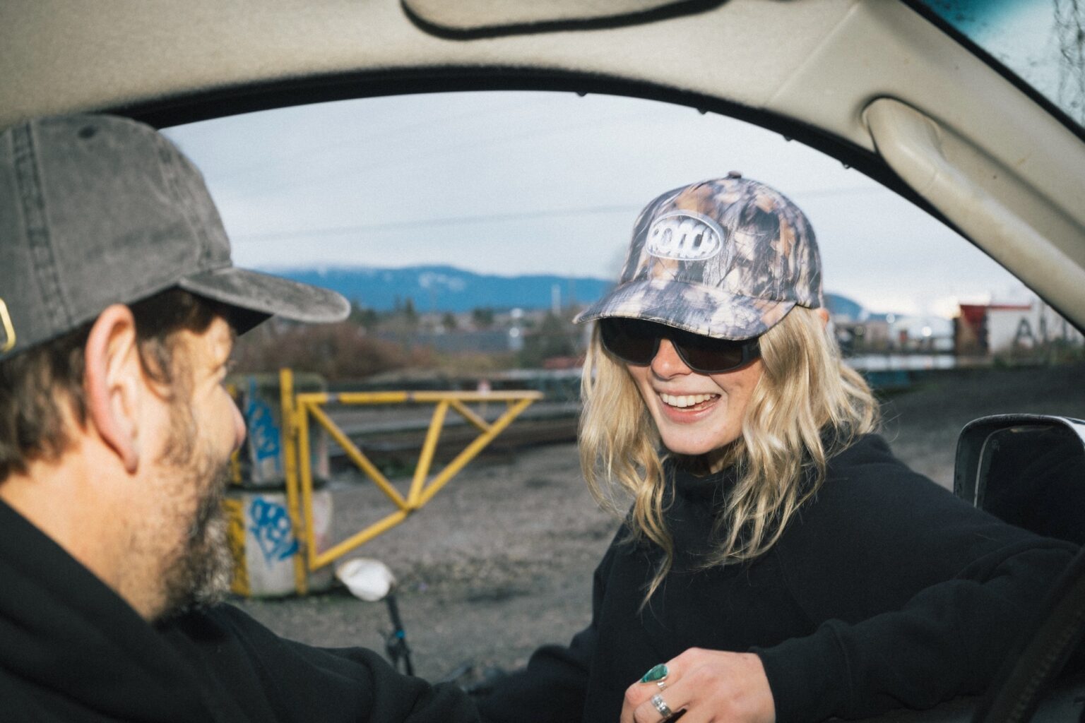 a female wearing the Roach camo hat talking to a guy.