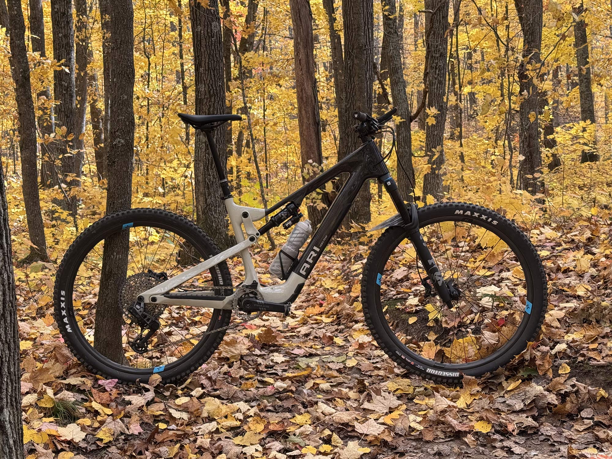 Ari Nebo Peak e-MTB Review: Light Weight eMTB Covers All the Bases (&Velocio Ultrapack Insulated Hoo Damp Ridesof Ground) Recon Backpack Review: Solid Options for Cold & Damp Rides 3 ari nebo peak eMTB in a forest with yellow leaves.