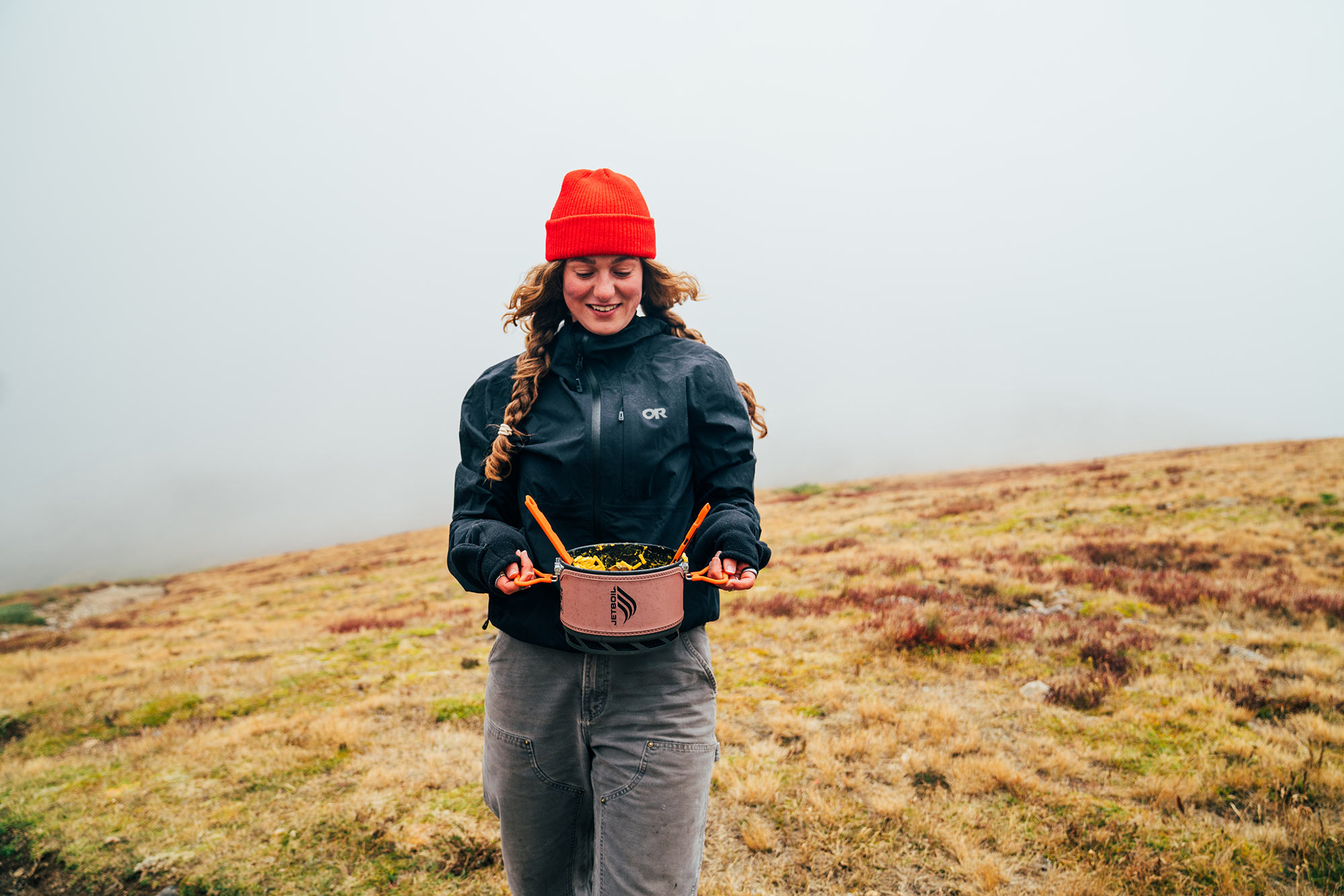 girl carrying jetboil trail cook 2 liter camp stove.