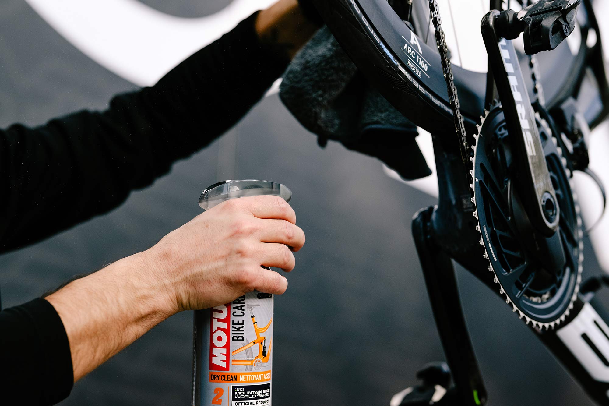 motul bicycle wash cleaner being sprayed on a bike.