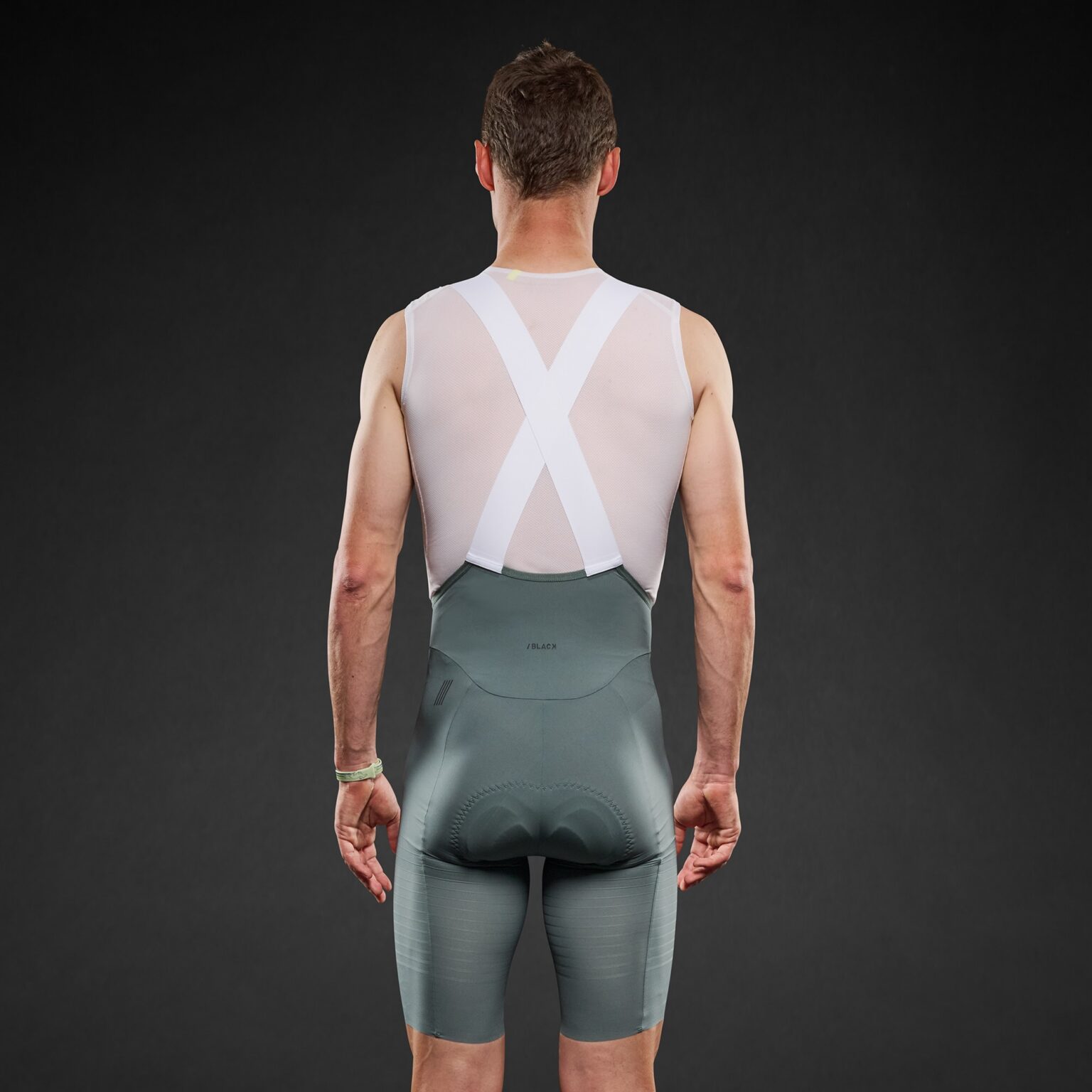 studio image of a man wearing the new Pi Black bibs viewed from the back.