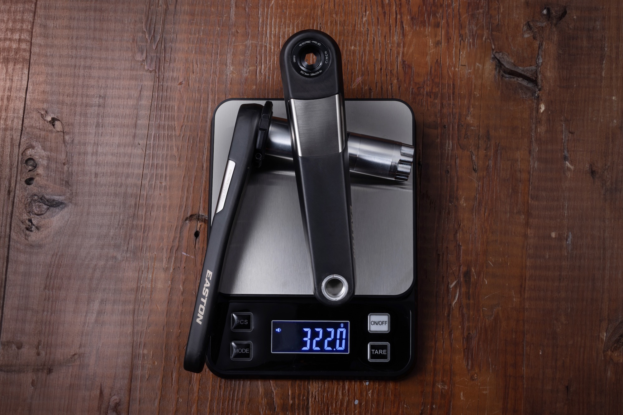 the Easton EC90 ALX cranks on a scale showing a weight of 322 grams
