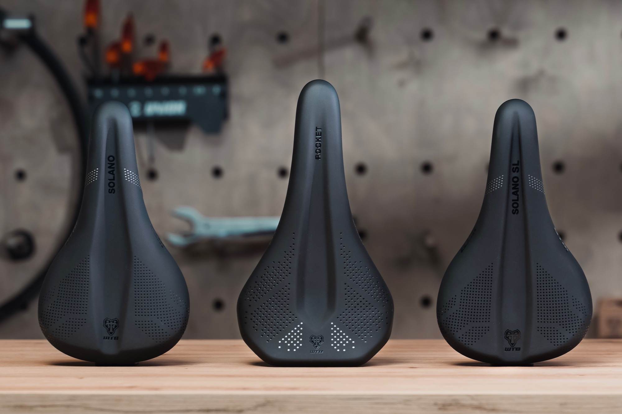 A photo showing three WTB saddles side by side on a work bench.