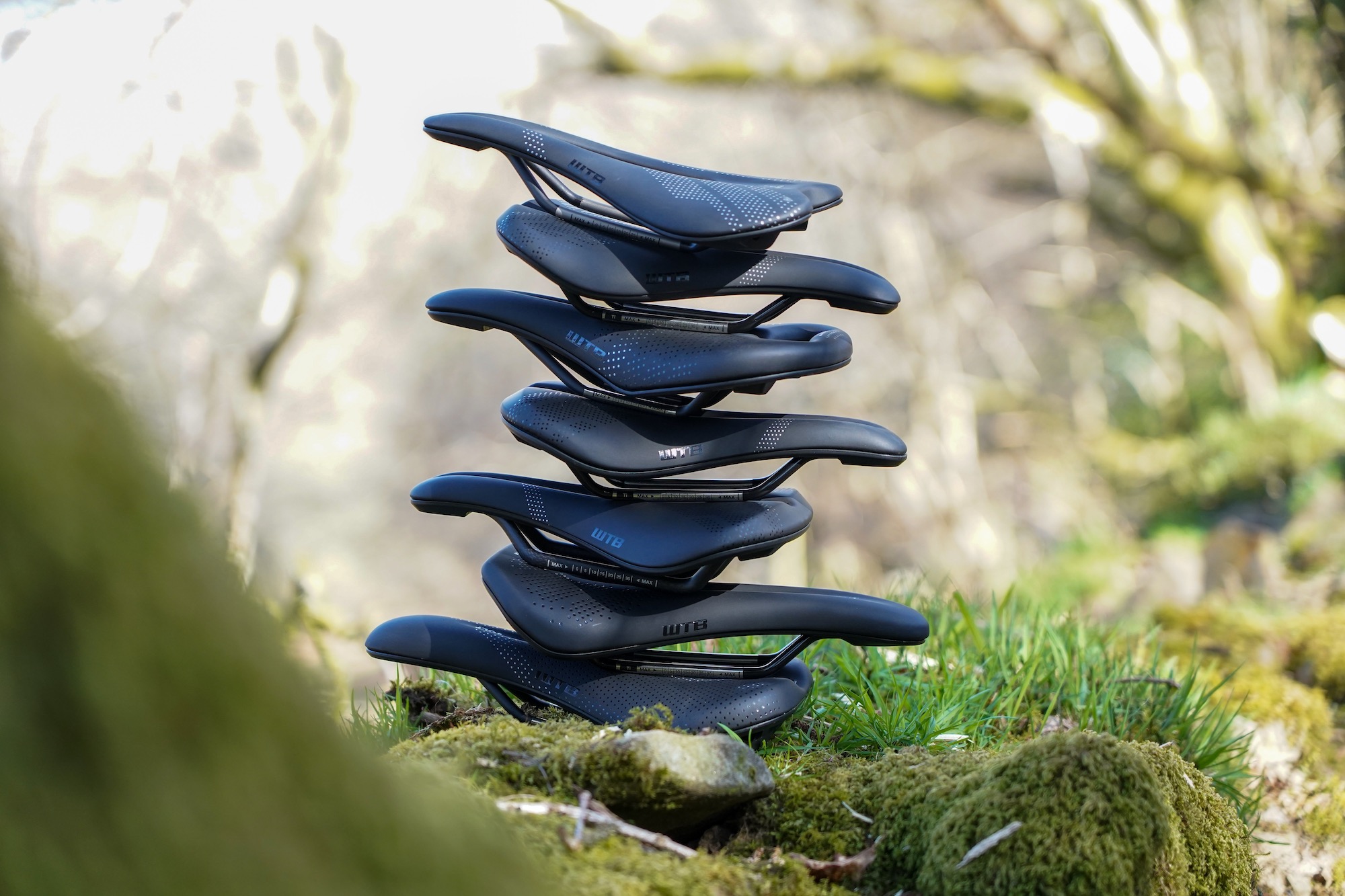 a stack of WTB saddles outdoors.