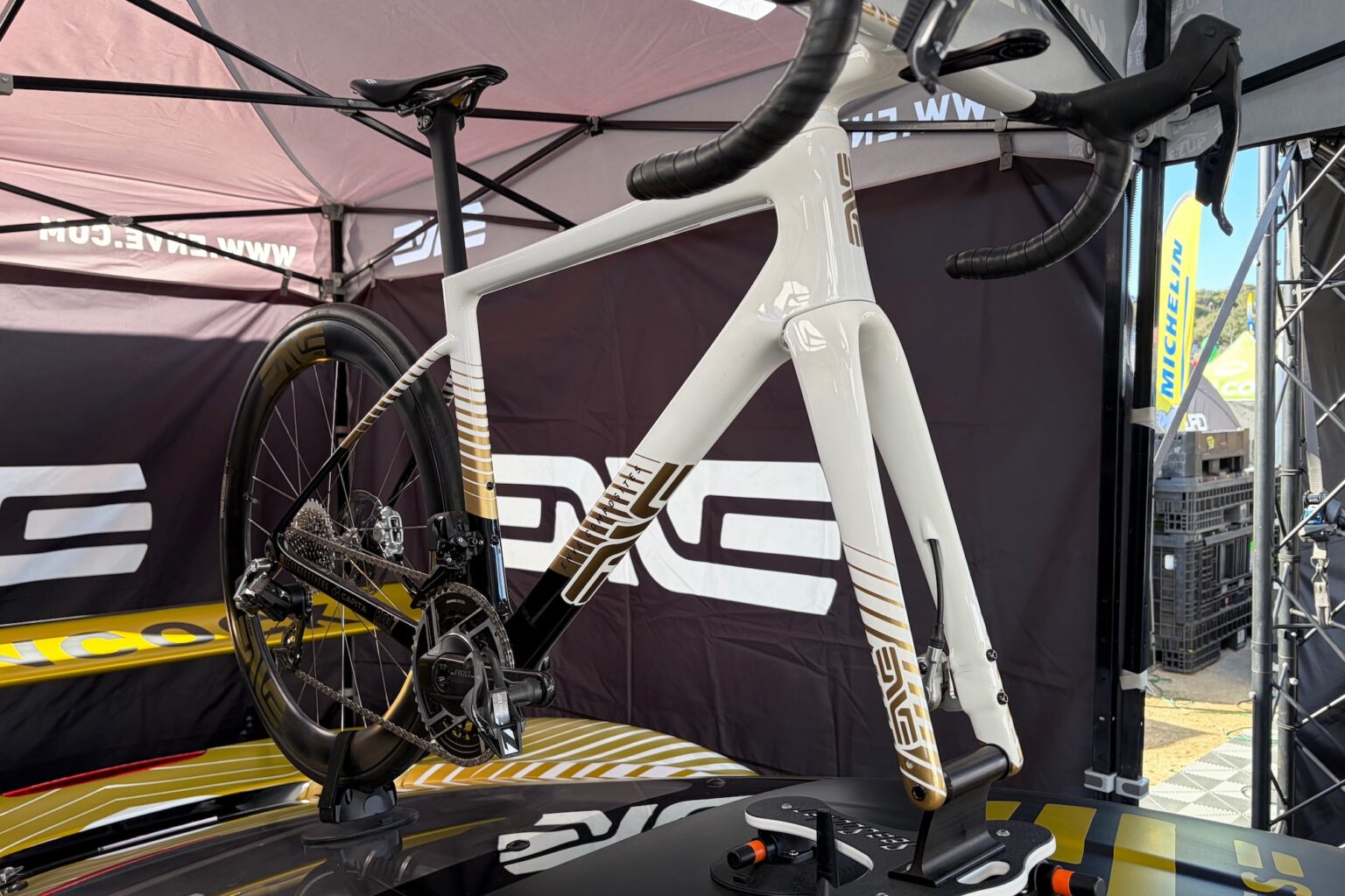 A custom painted Enve road bike on the roof of a ferrari