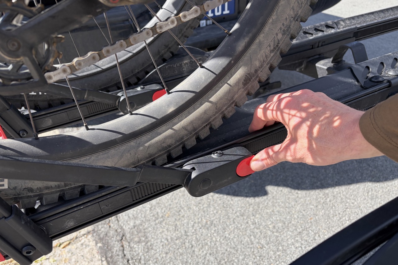 pressing the red button to release the wheel arm on the Hollywood CrossTrack rack