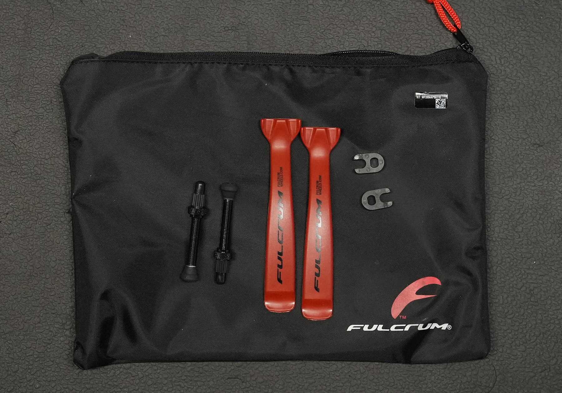 accessory pouch with tire levers for fulcrum rapid red carbon gravel wheels.