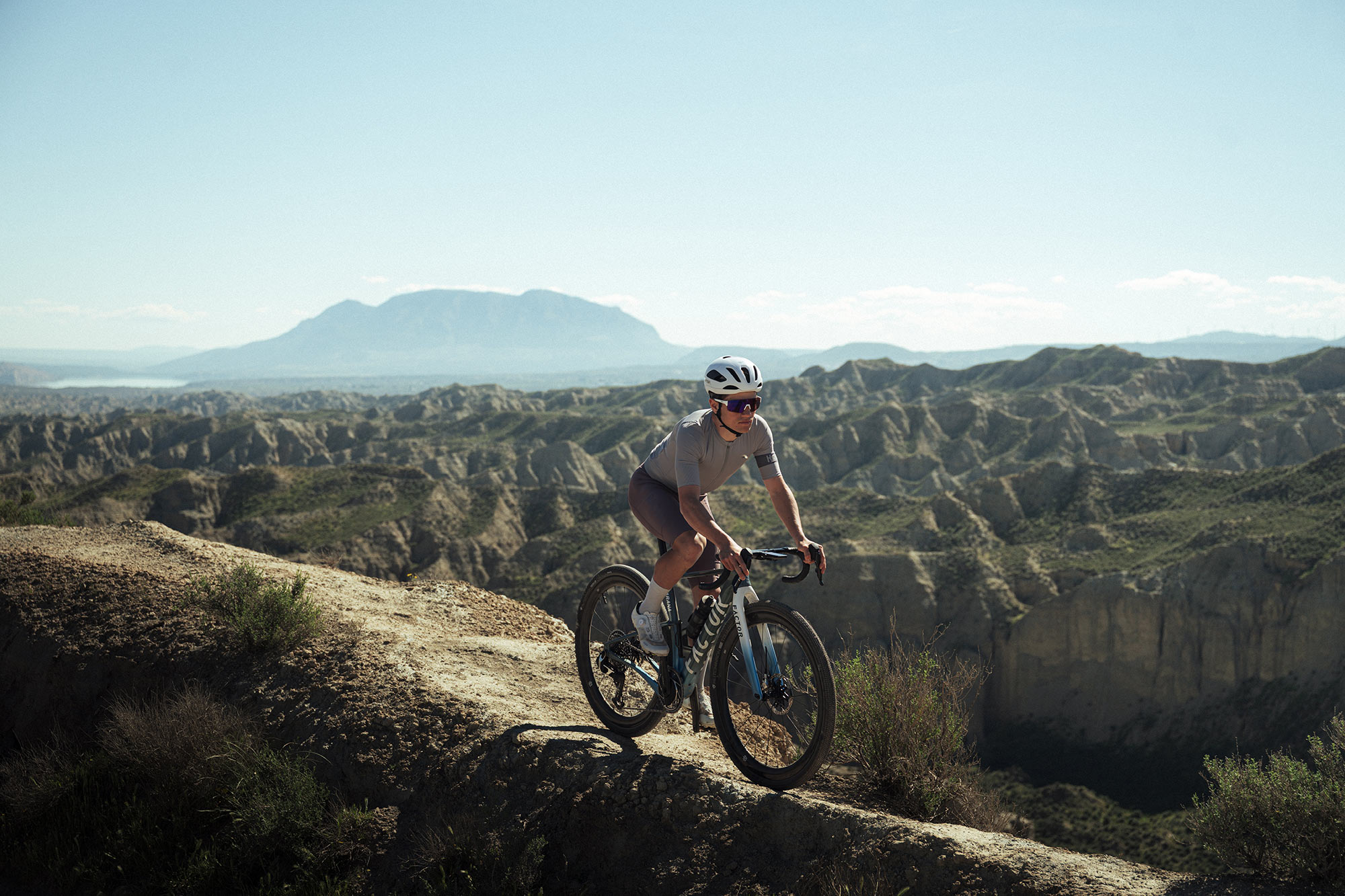 cyclist on a ridge riding the factor sarana gravel bike