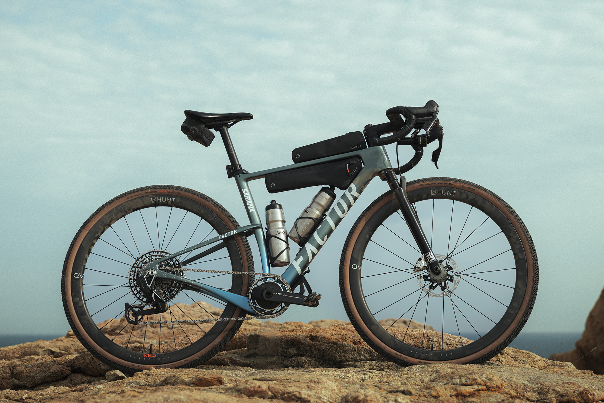 factor sarana gravel bike shown on a hill with frame bags.