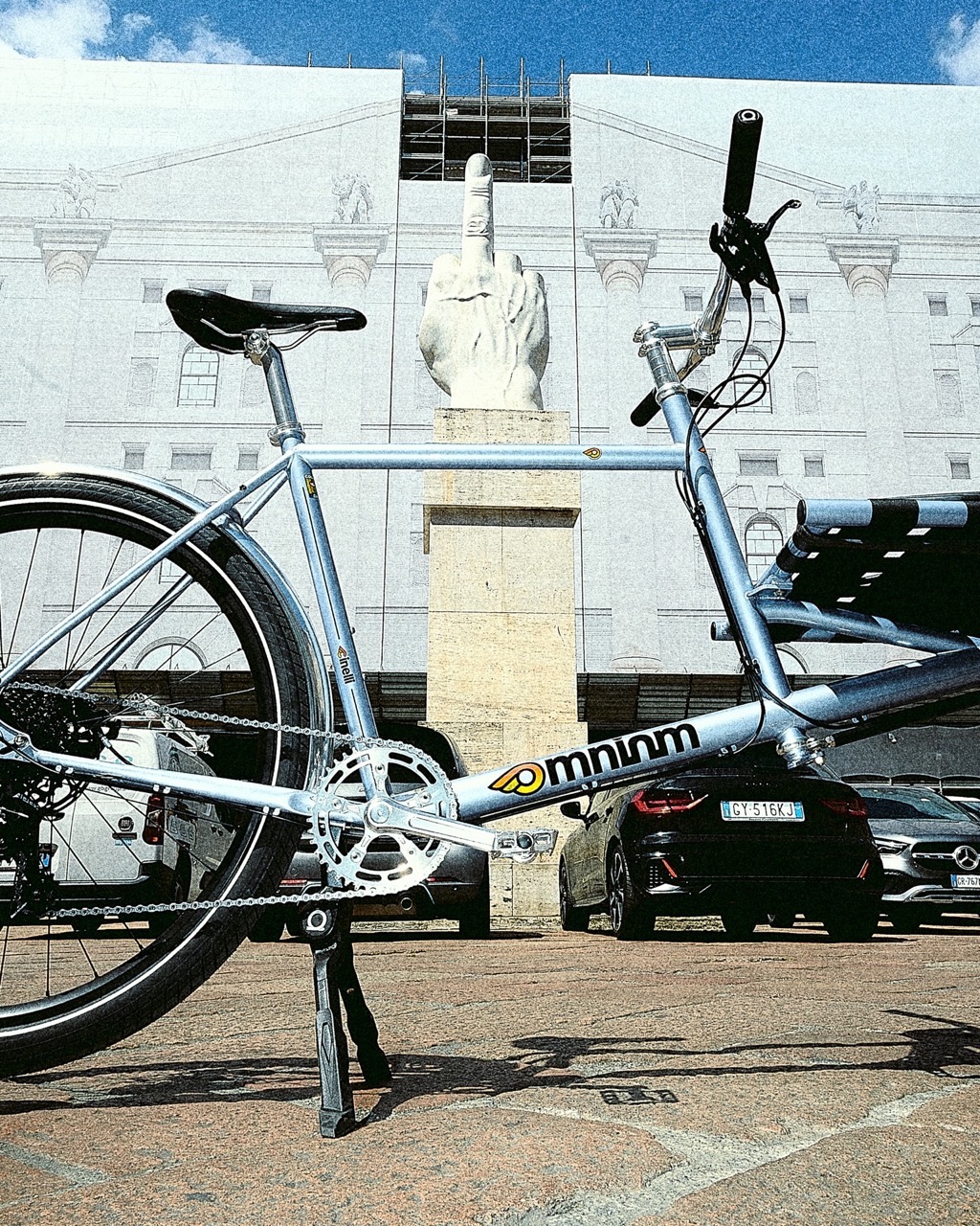 The Omnium x Cinelli Supercargo bike parked in front of a statue of the middle finger