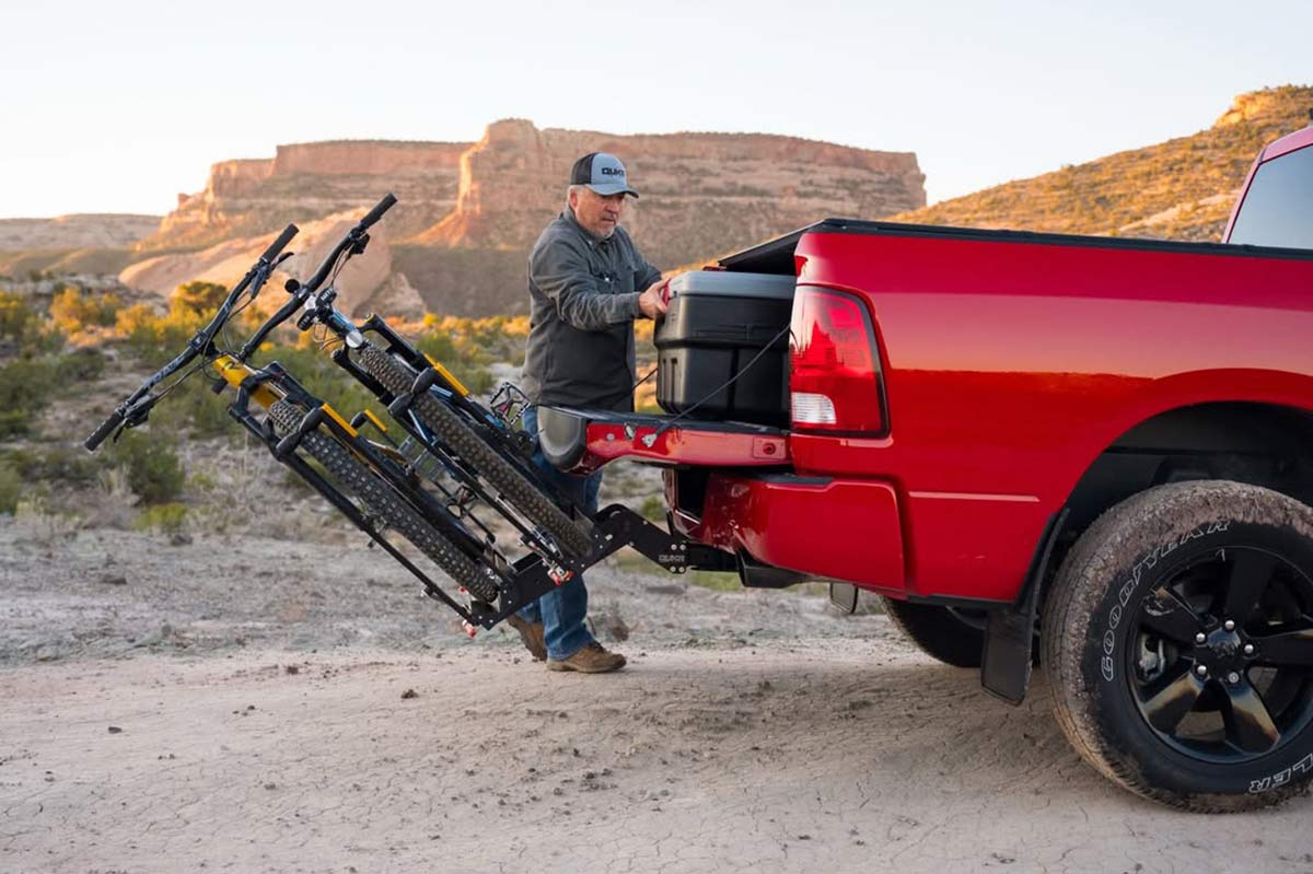 QuikrStuff hitch bike rack tilting down to open truck bed.