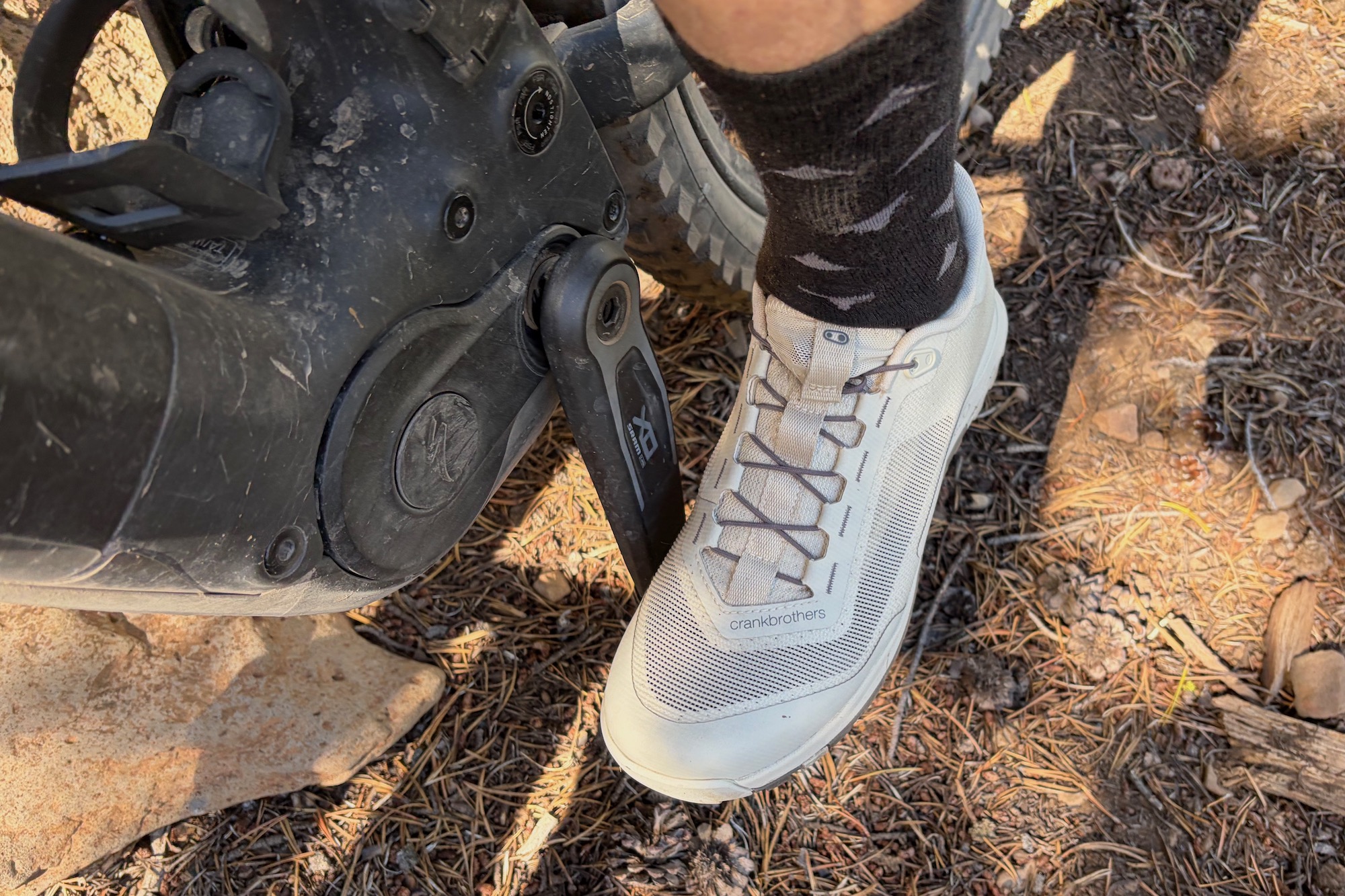 wearing the Mallet Trail vent shoes with a foot on the pedal during a test ride.