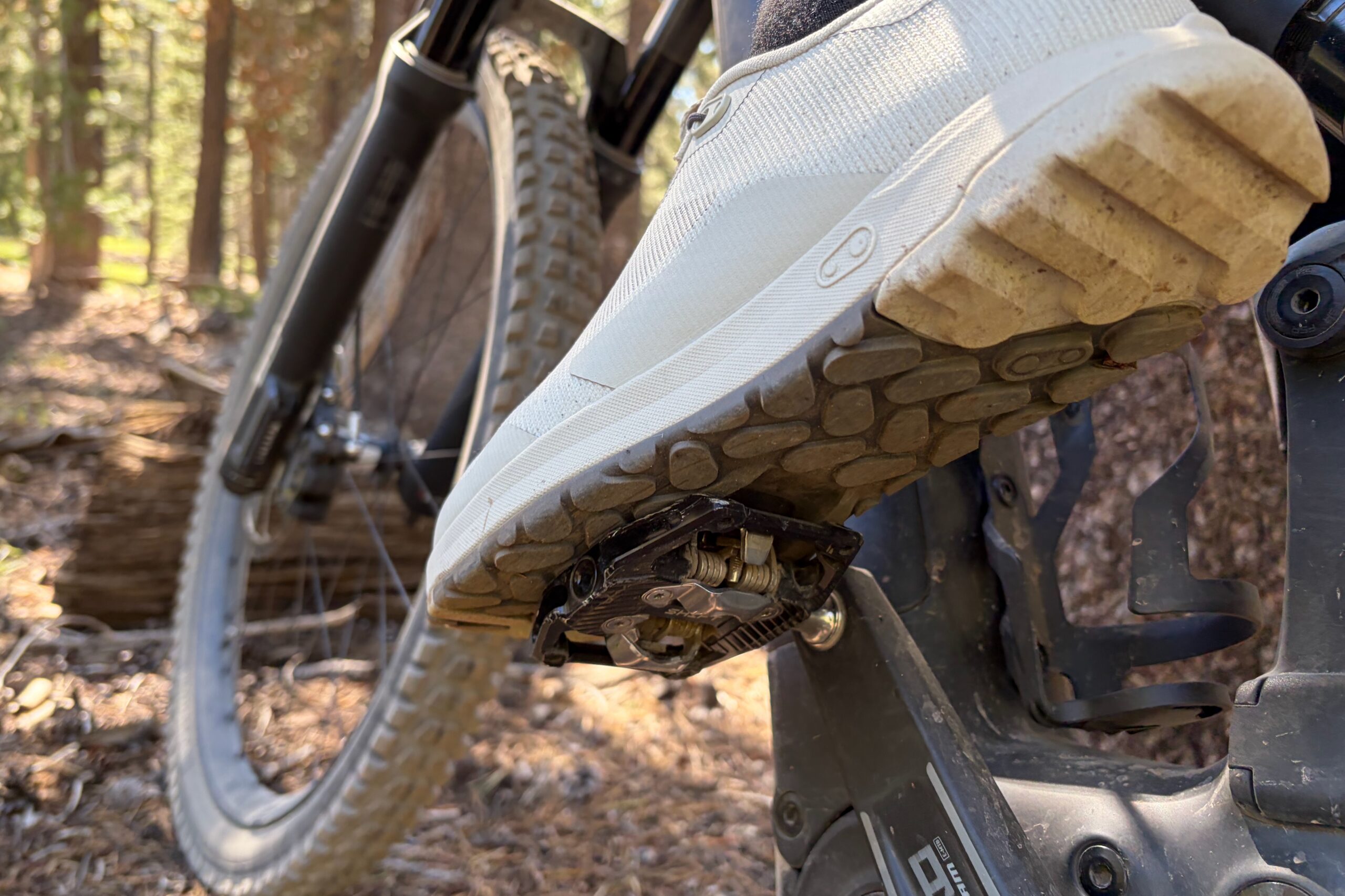 wearing the CB Mallet Trail shoes on a test ride with a foot on the pedal