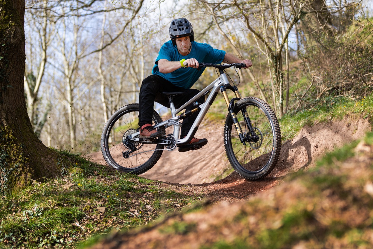 a man riding the Canyon Torque AL down a trail.