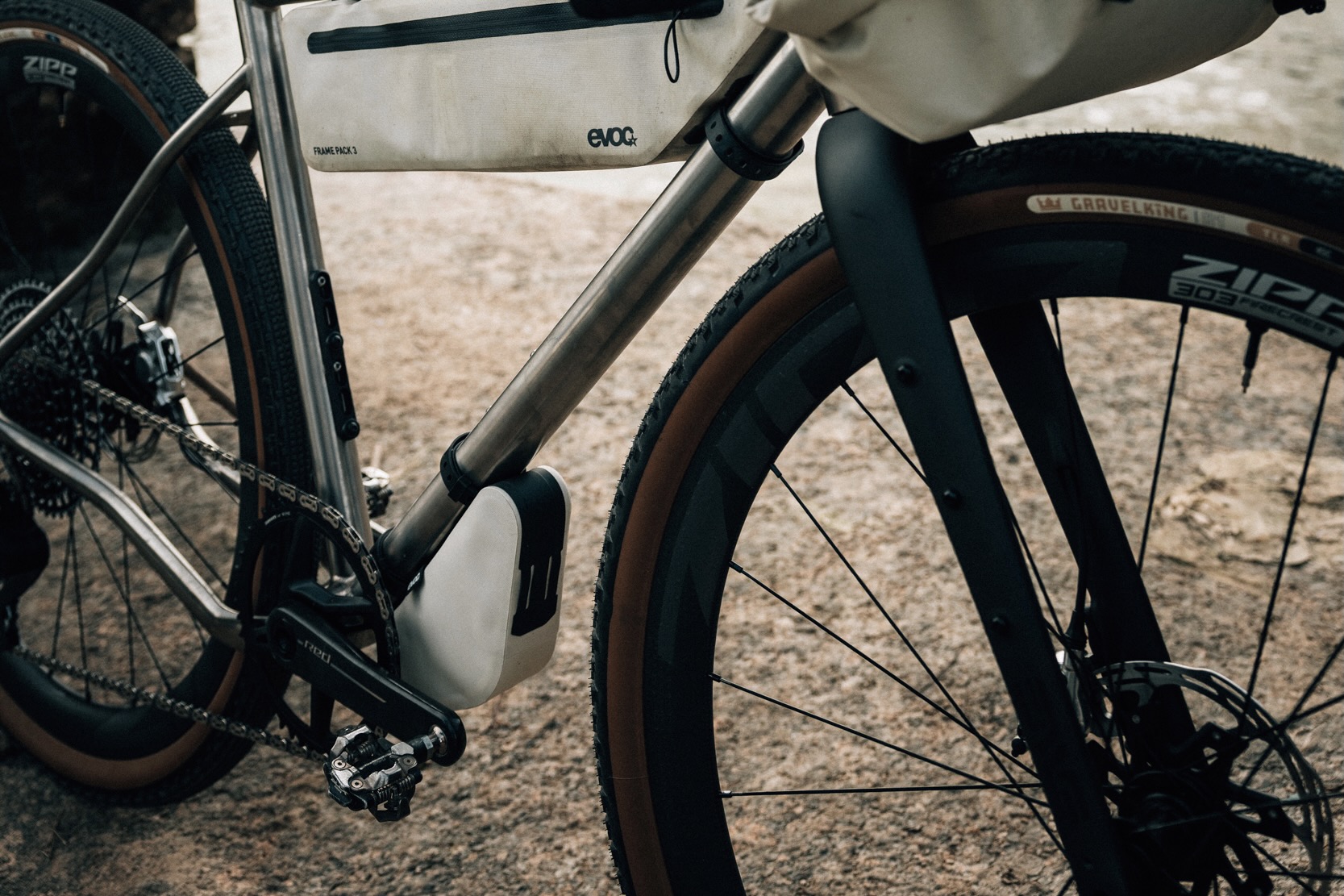 the Evoc Multi-pack mounted on the underside of a touring bike downtube.