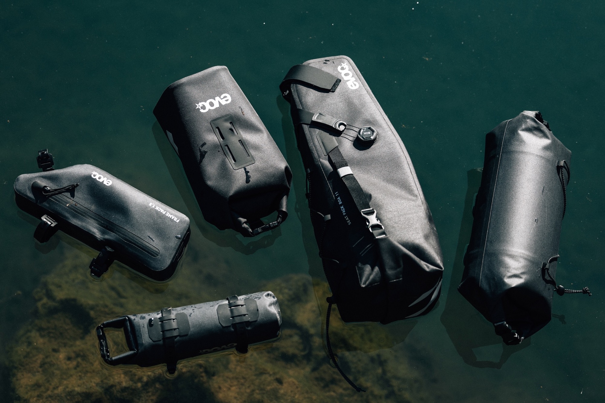 Evoc's Bikepacking Collection Bags floating on water.