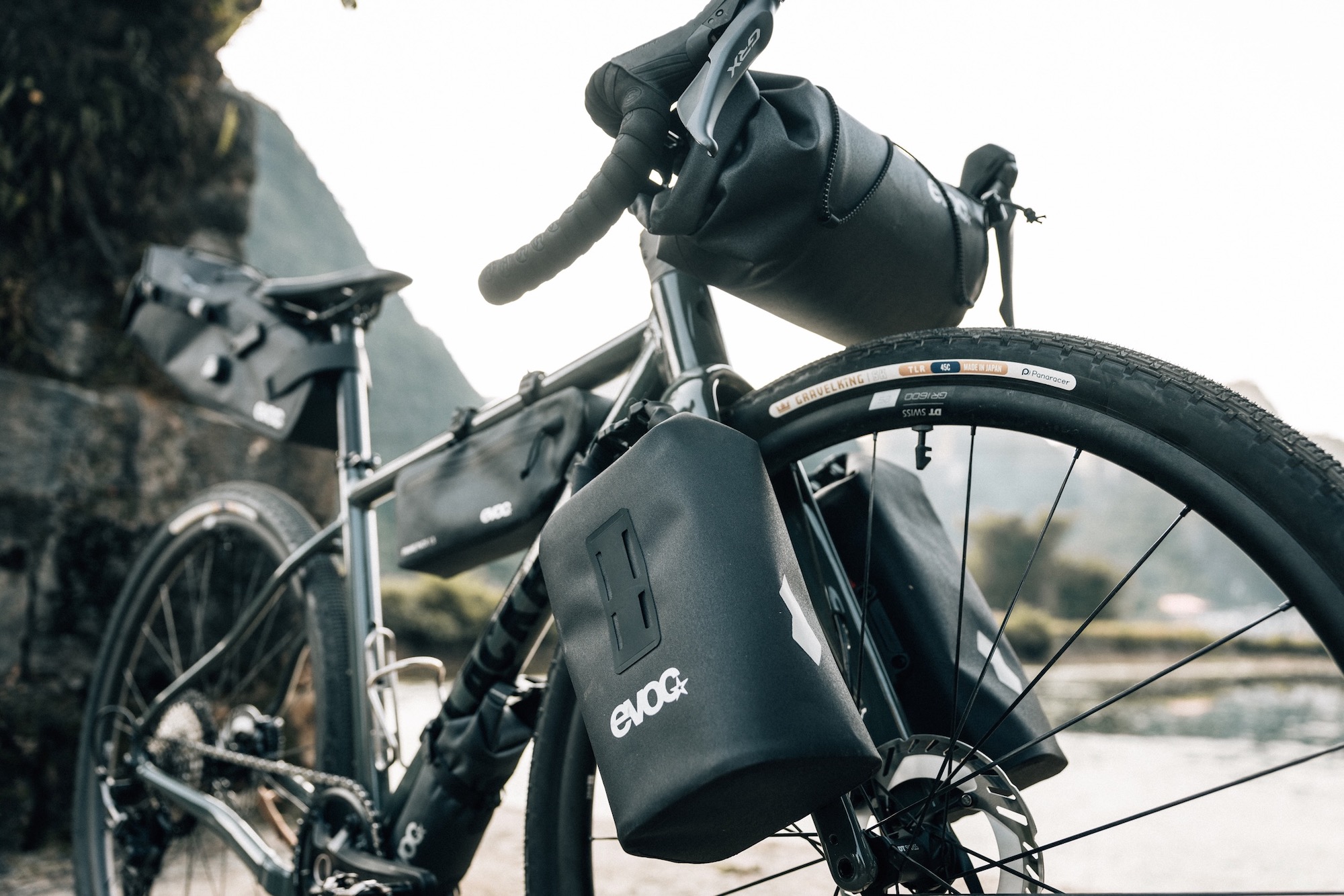 a gravel bike loaded up with many of the new Evoc Bikepacking Collection Bags.