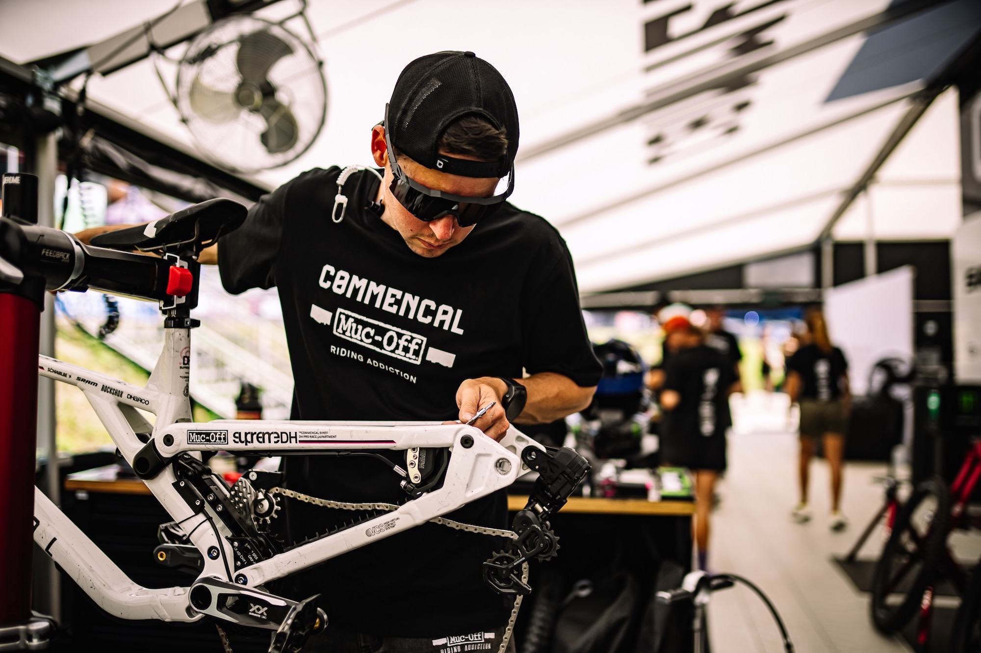 a bike mechanic wrenching on the new Supreme DH V5.2