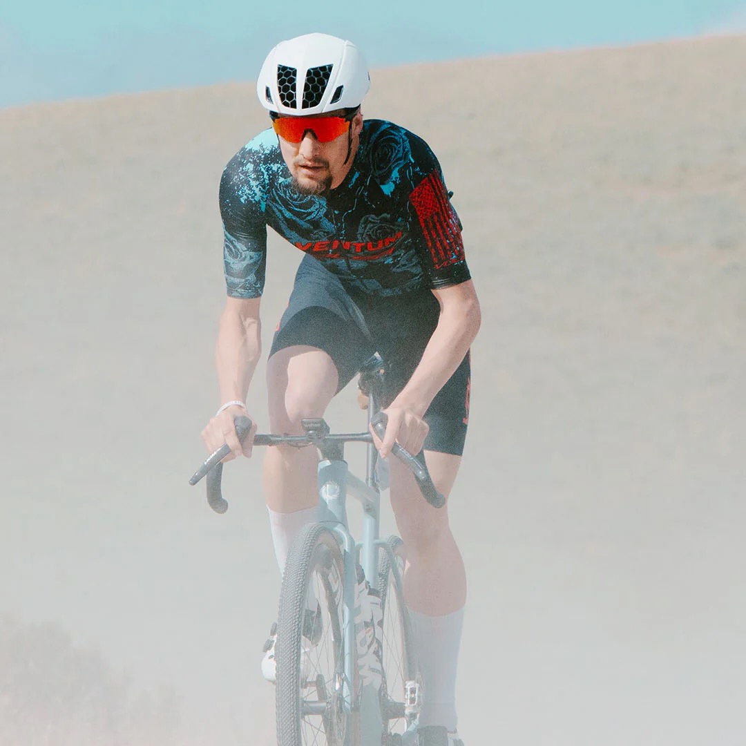 image of a man riding a gravel bike wearing the the KAV Silvo in white