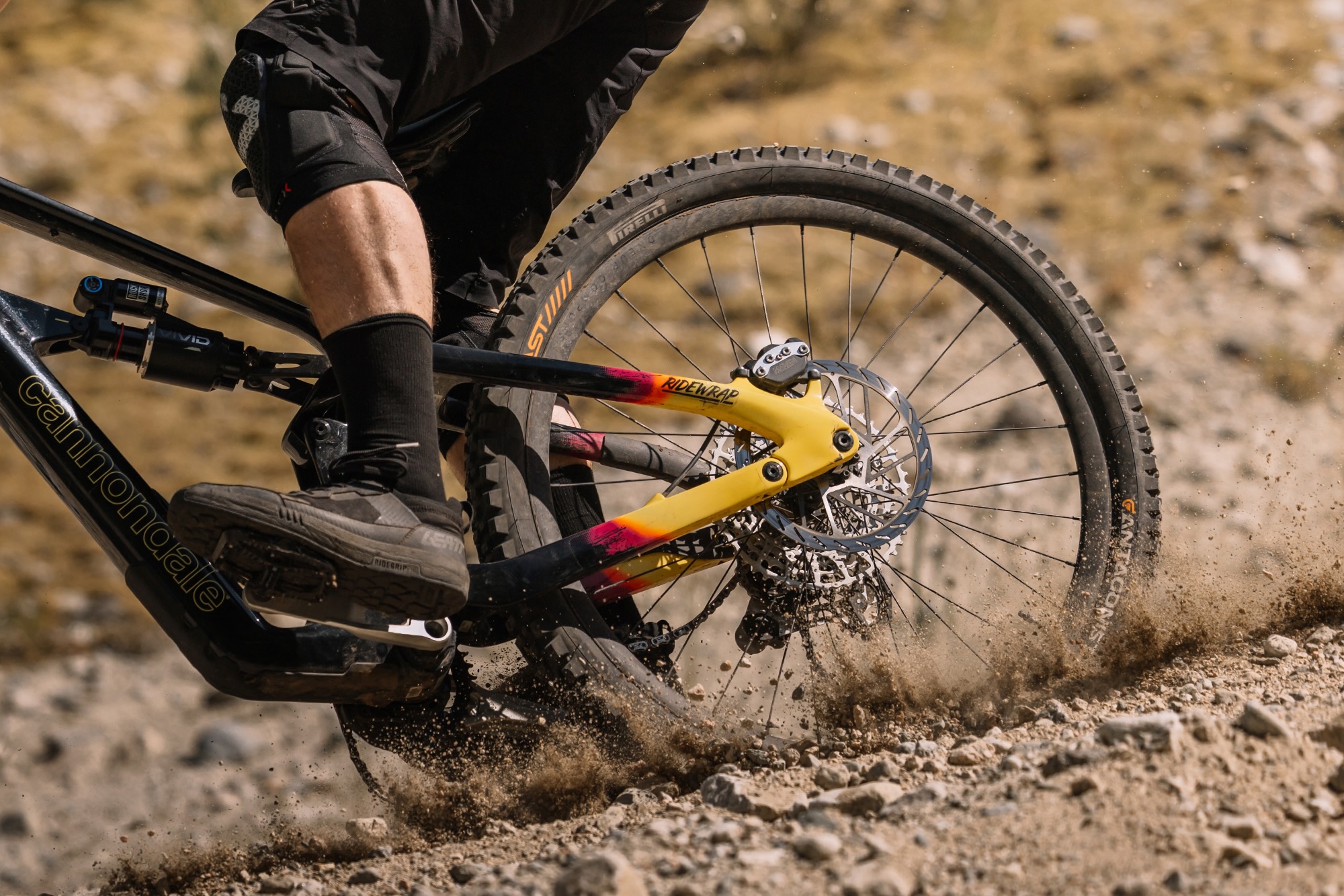 en person, der cykler ned ad et tykt spor og kaster lidt op med OneUp aluminiumshjulene.