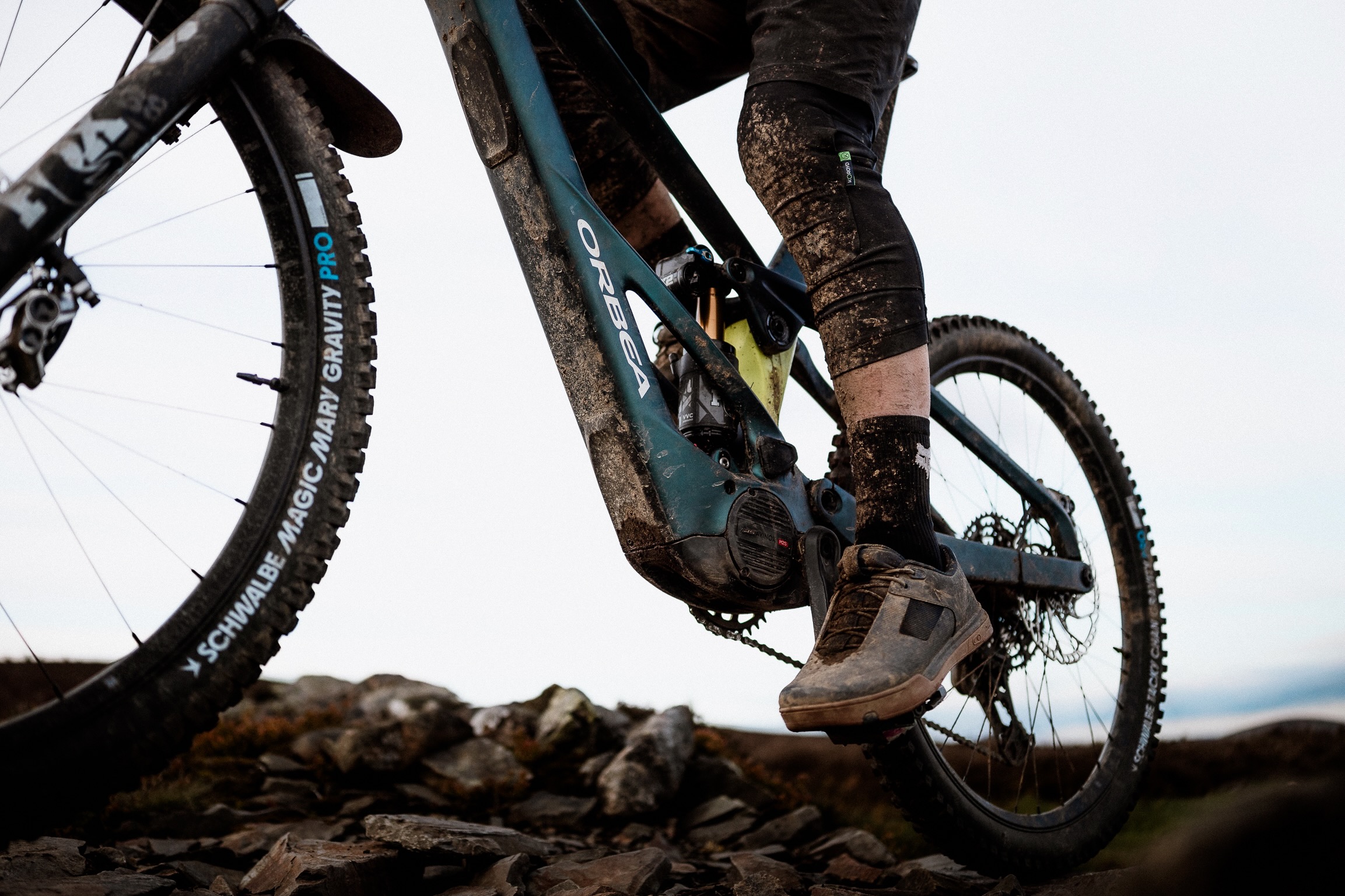 a rider pedaling aboard the Orbea Wild eMTB