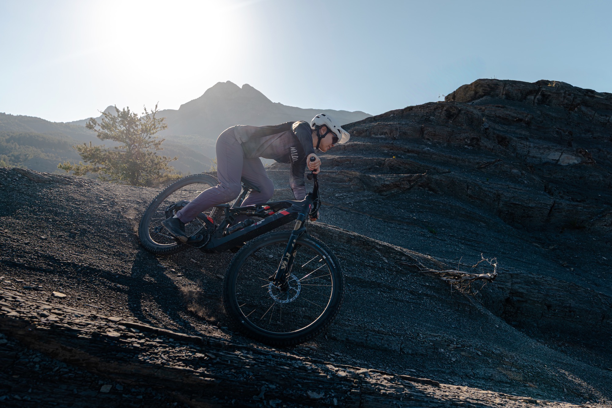 a female rider on the Rotwild R.XX eMTB riding some wild, flowy terain.