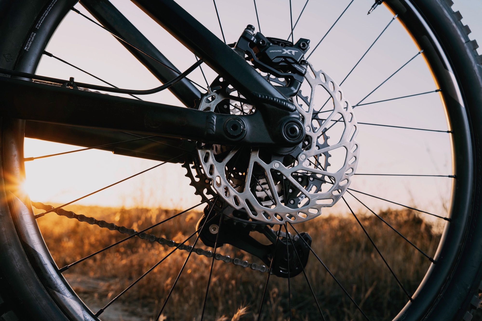 the shimano 2.2mm thick rotor mounted on the rear wheel of a mountain bike.