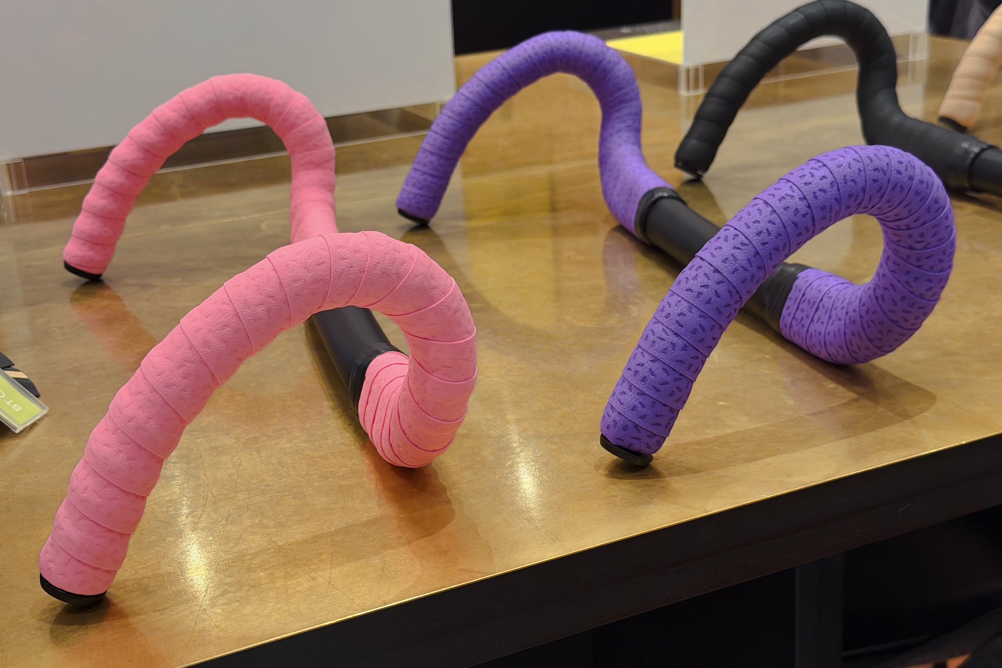 two handlebars wrapped with Ergon BT tape on display at Eurobike