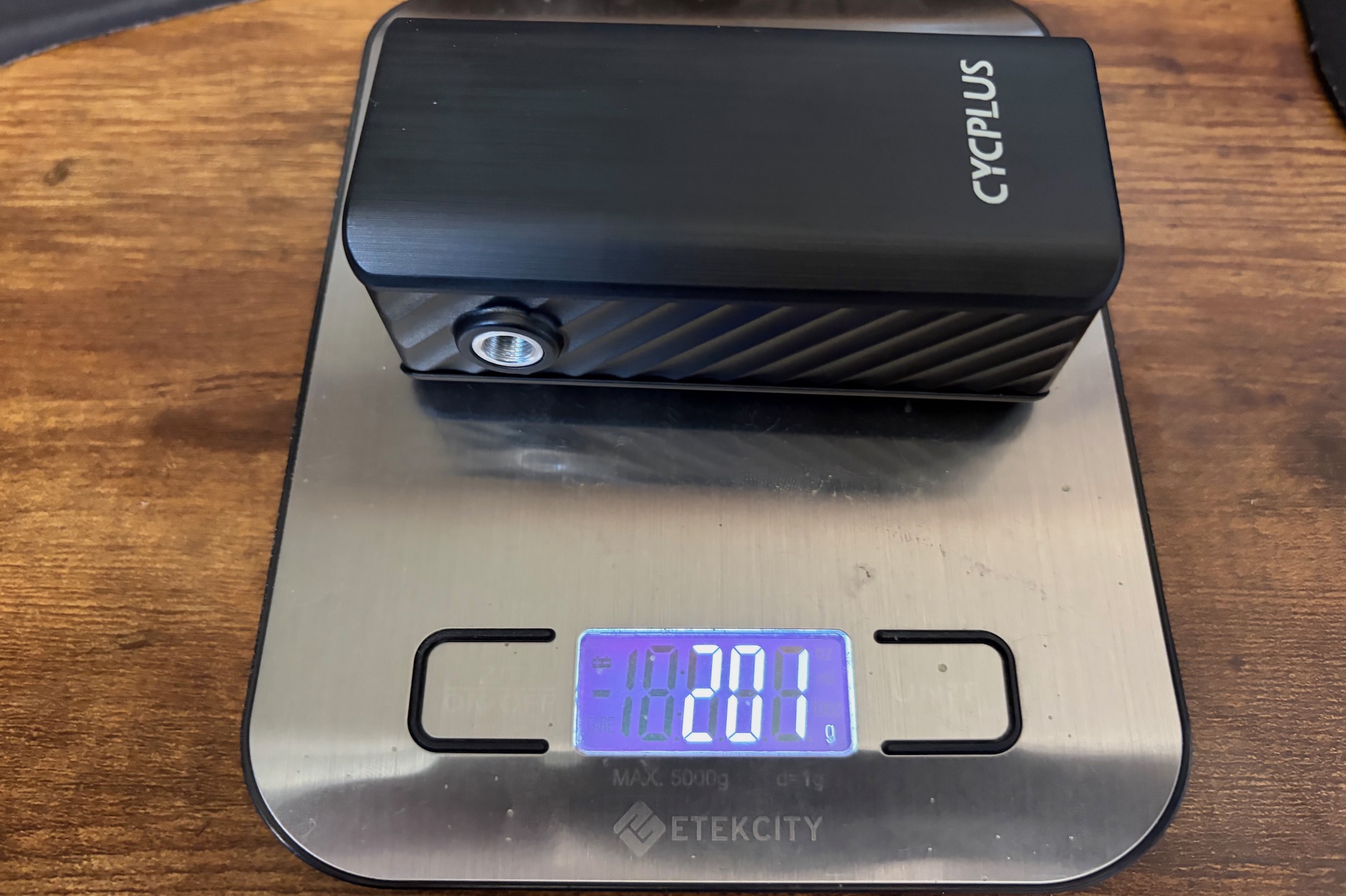 the Cycplus A3 Mini on a digital scale with a weight of 201 grams