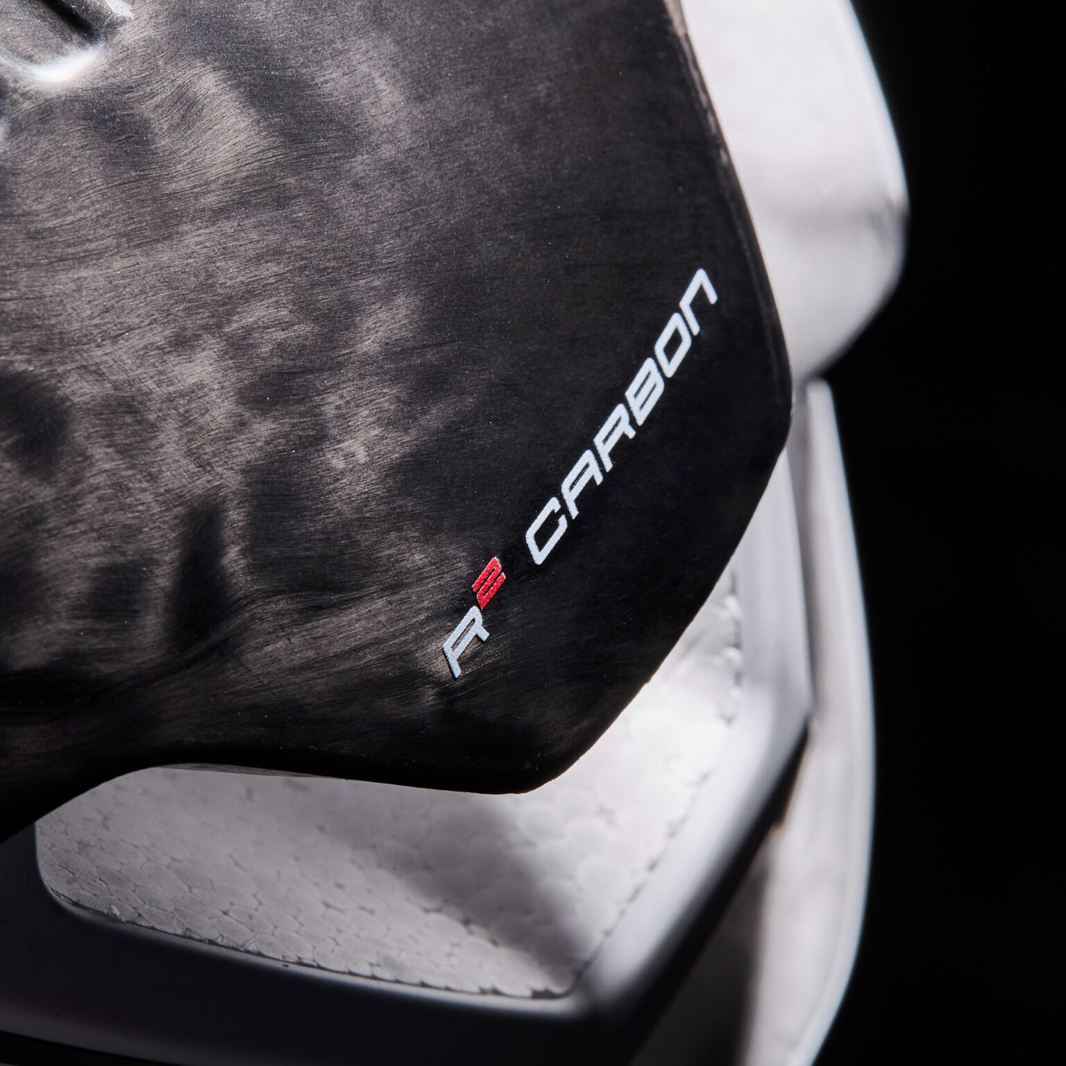 studio image showing the R2 carbon logo on the EKOI helmet