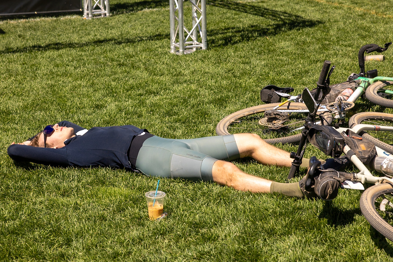 a rider relaxing in the grass after participating in Truckee gravel