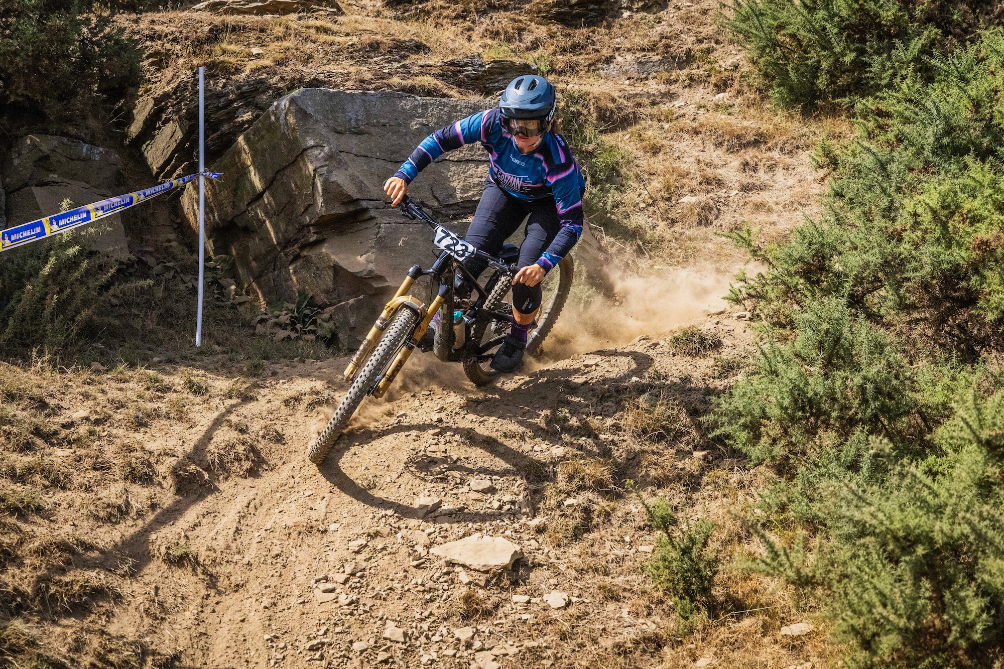 a rider on the Boyd Bracken Trail wheels going around a dusty corner.
