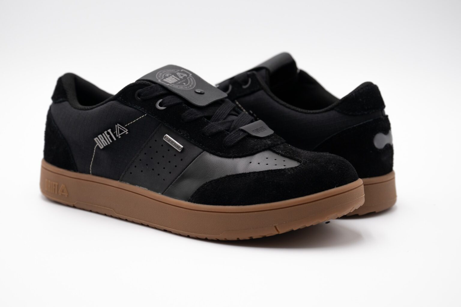 studio image of a pair of Drift Minna shoes in black