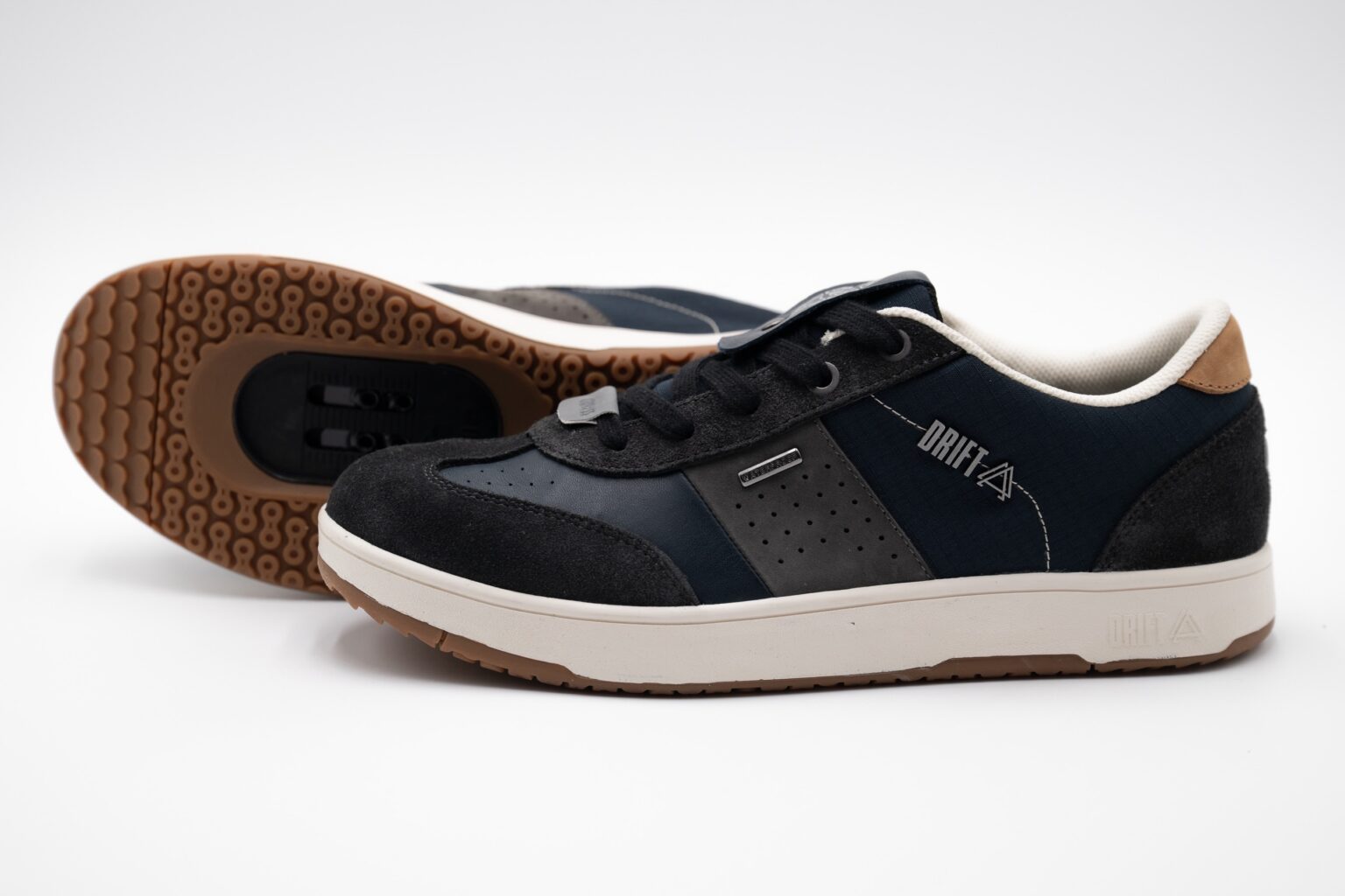 studio image of a pair of Drift Minna shoes in navy