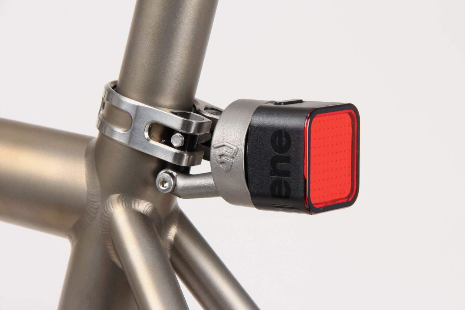 studio image of the Firefly Radar Mount on a bike with  a small square light attached.