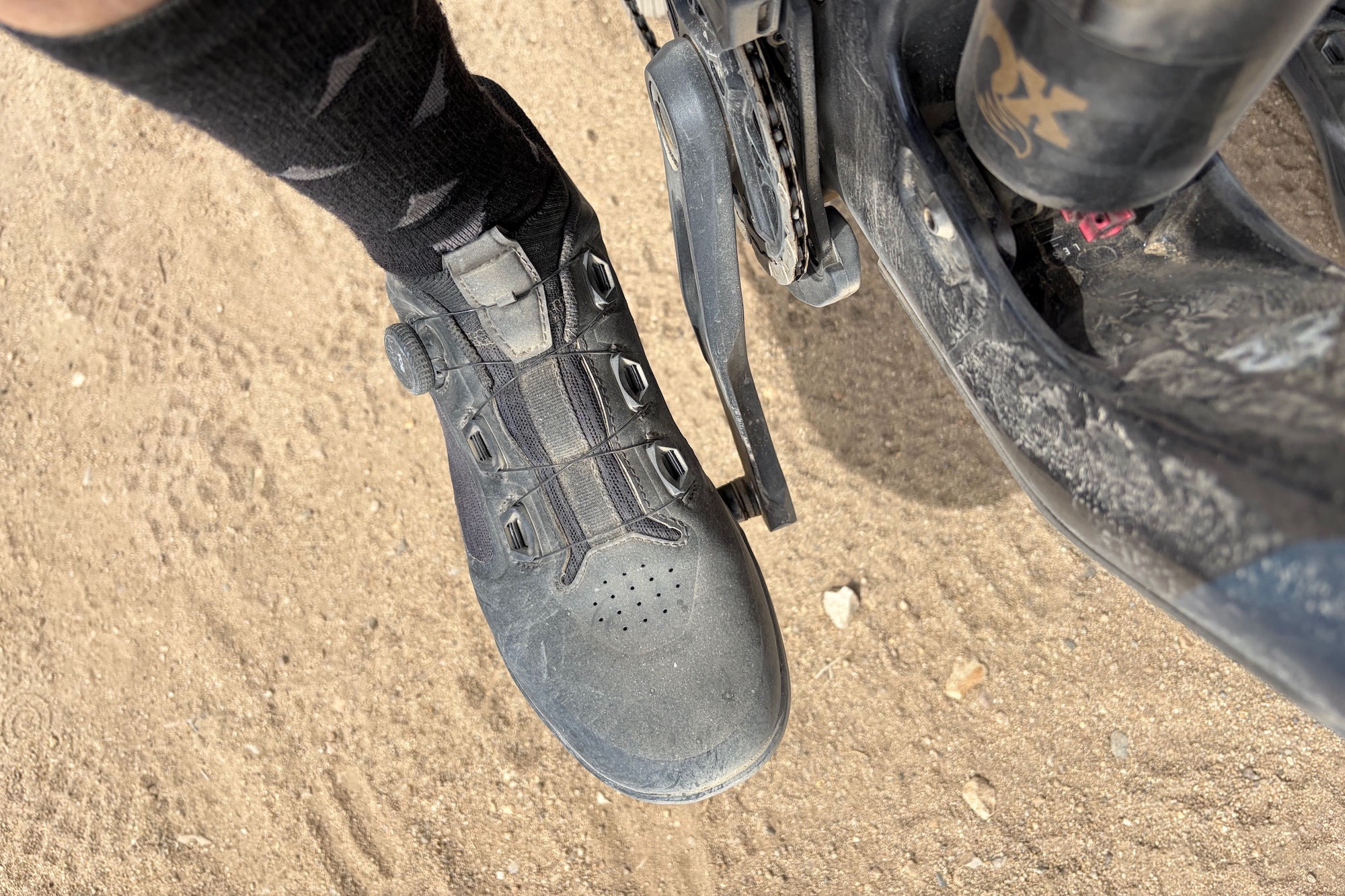 wearing the giro chamber trail shoes with a foot on the pedal of a mountain bike