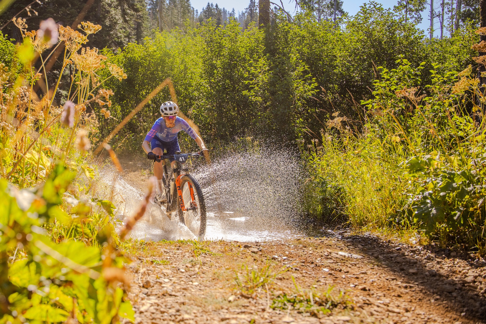 Haley Smith splashing through a creek crossing while racing the Downieville Classic DH