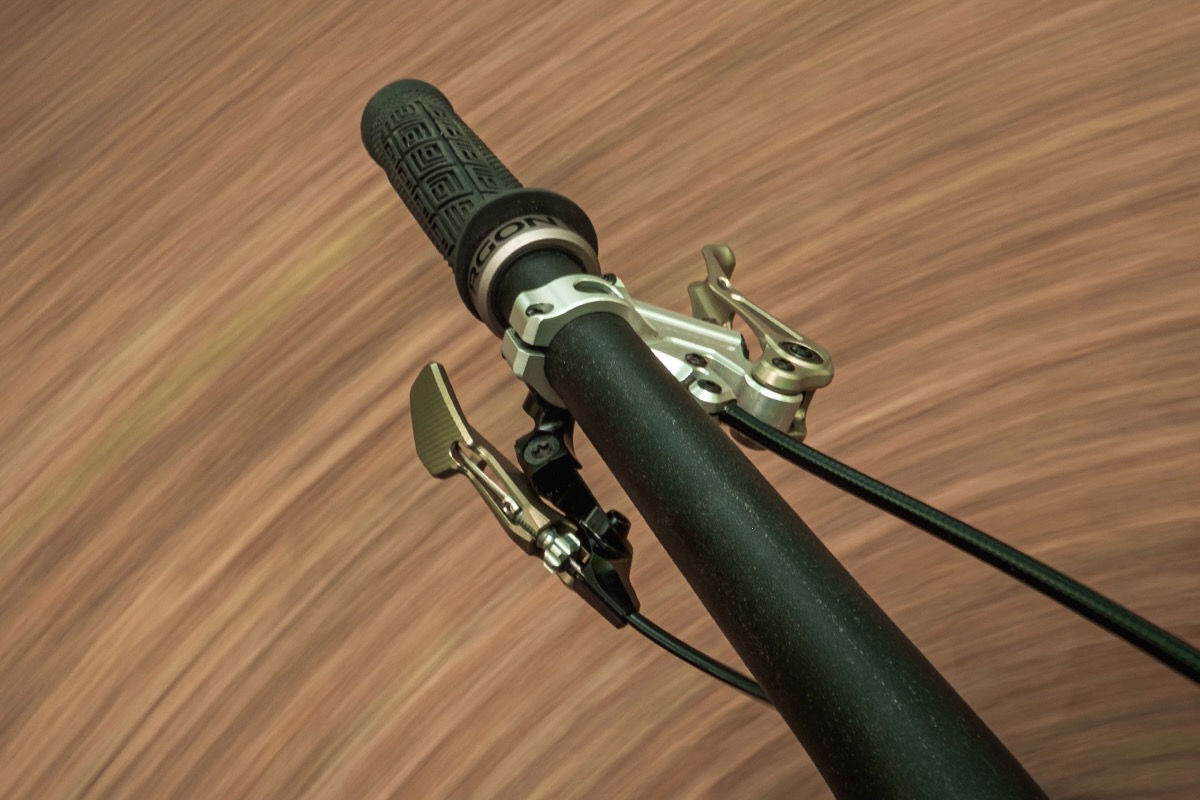 The Intend Elevator Boy dropper remote mounted on the handlebar of a mountain bike.