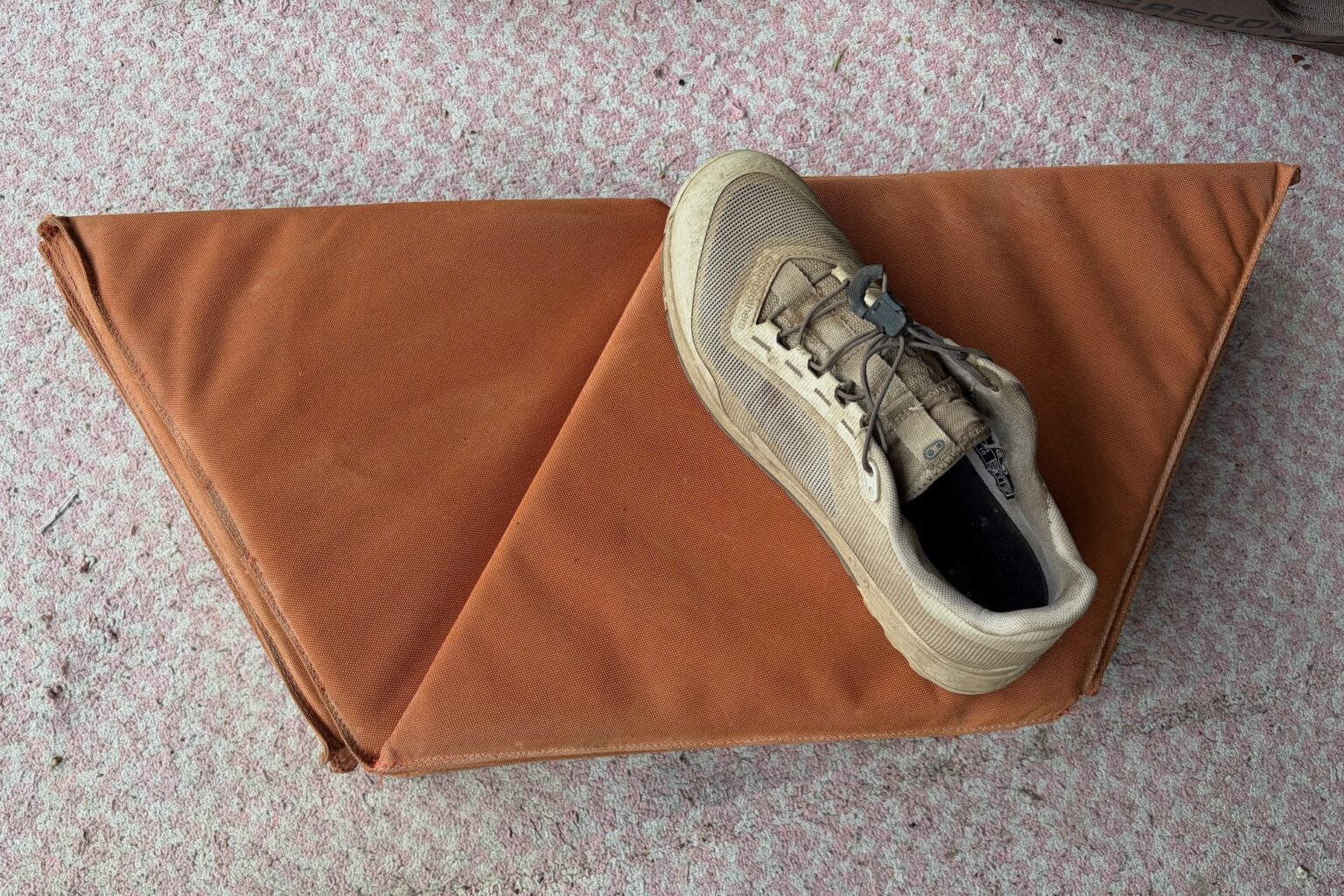 the folded kama mat wit a shoe for scale