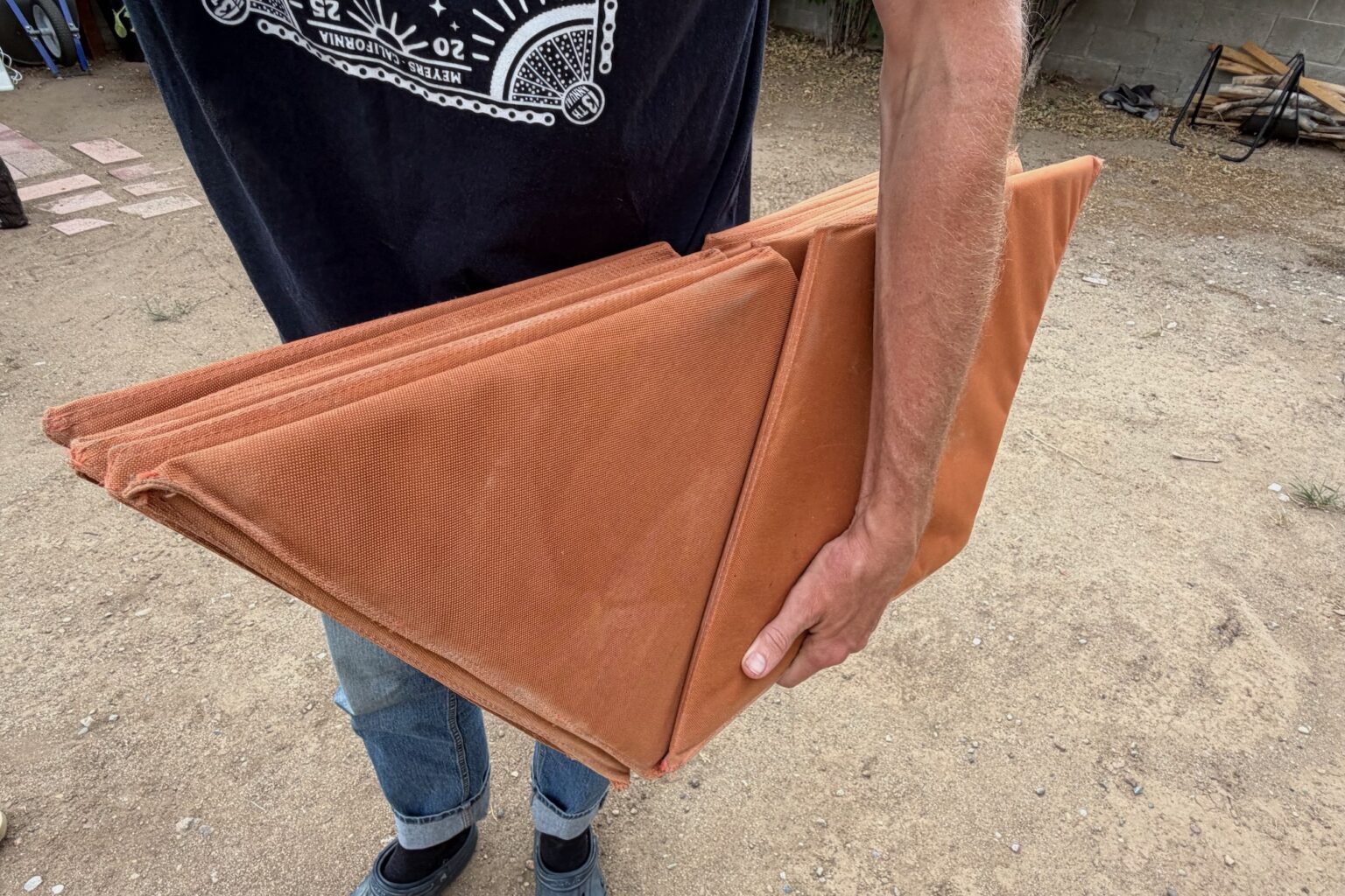 holdling a folded kama mat