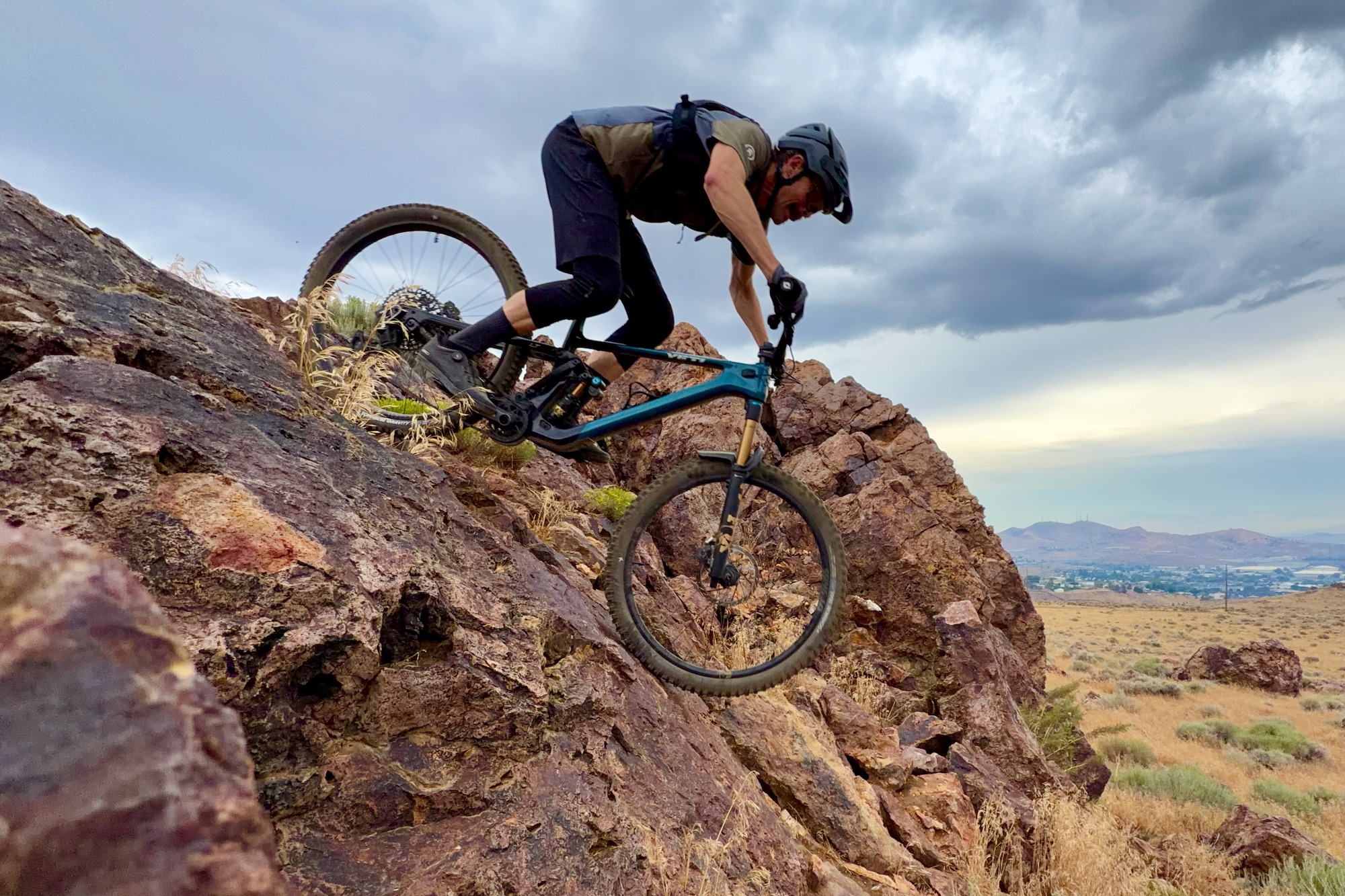 riding over a steep rock roll wearing the Giro chamber trail shoes