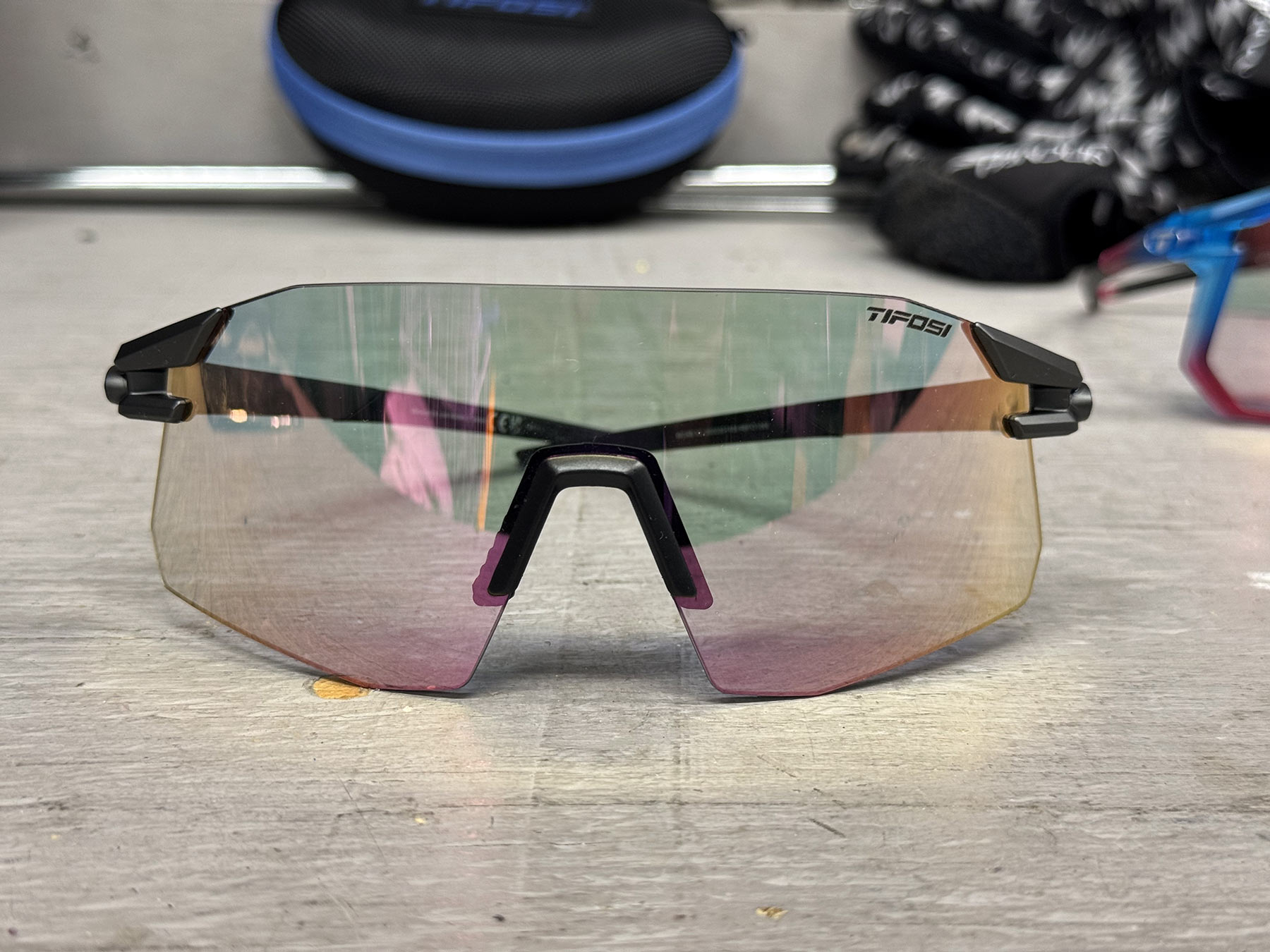 tifosi moab XC sunglasses with pink fototec lenses on a workbench.