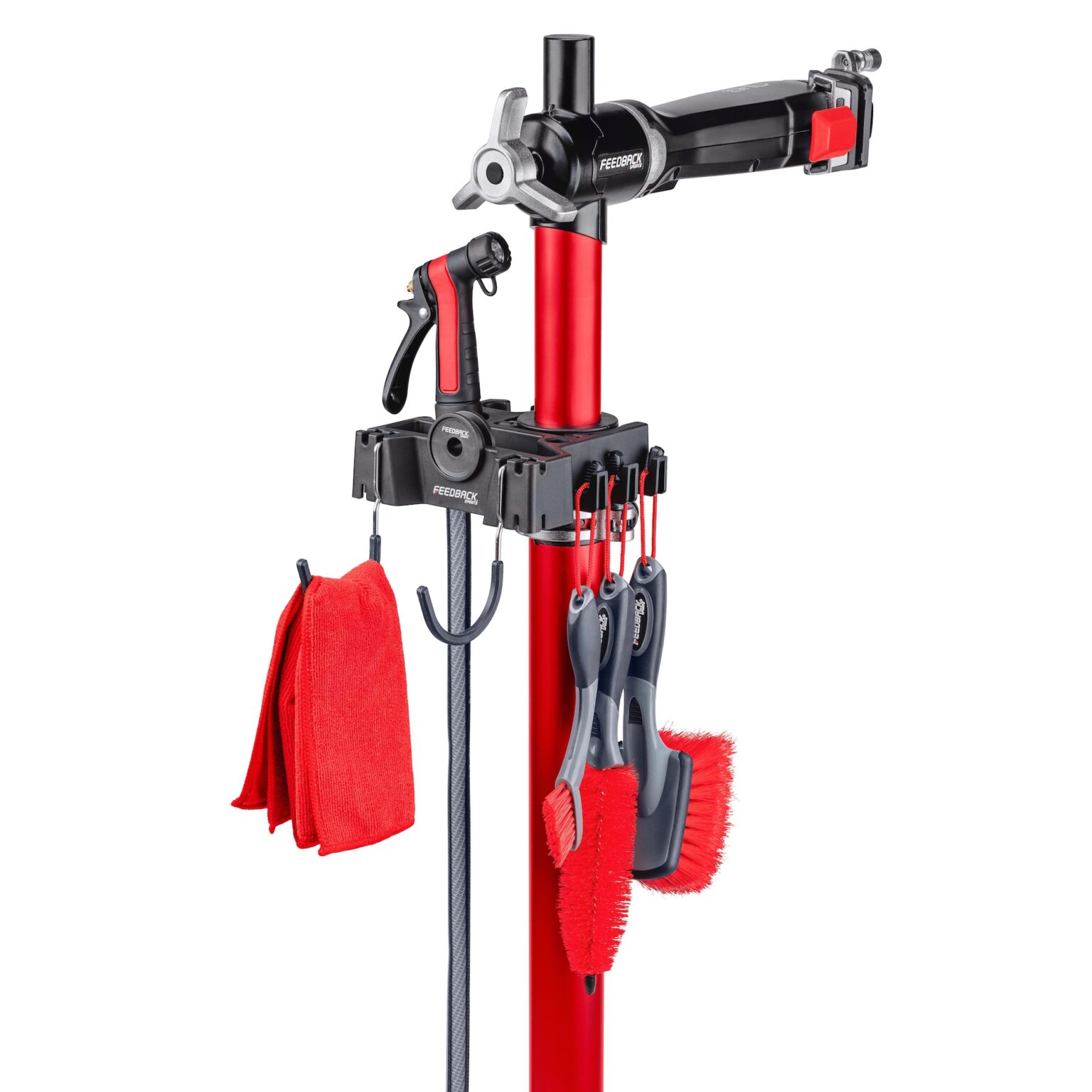 studio image of everything included in the Feedback Sports Brush Bar kit mounted on a repair stand with a hose, too.