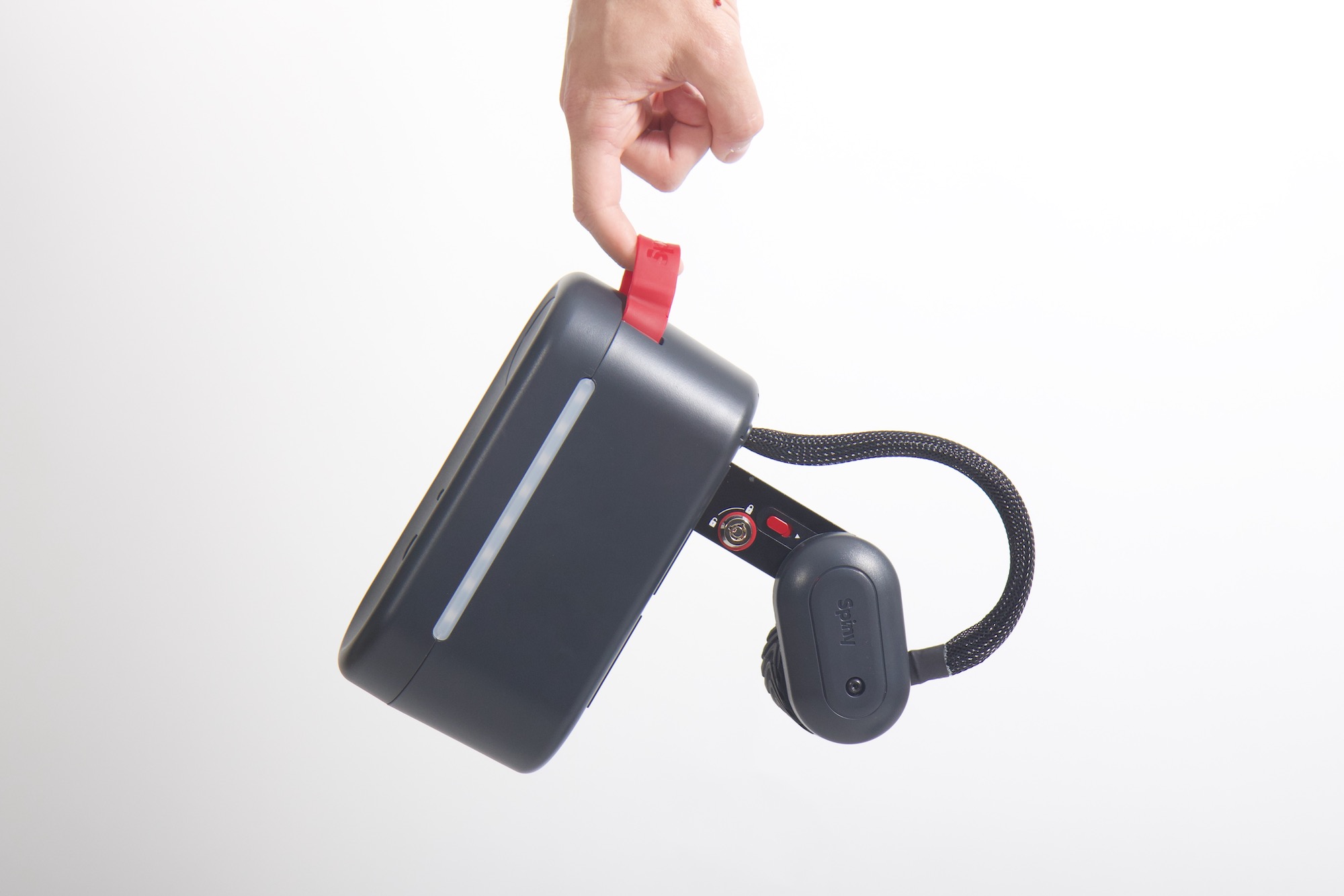 studio image of a hand holding the Spiny 2 by one finger