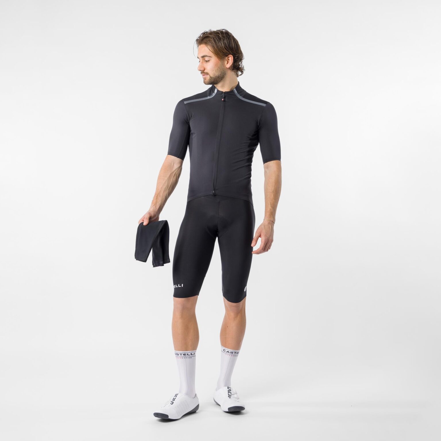 studio image of a man standing in the Gabba Pro jacket with no arm warmers