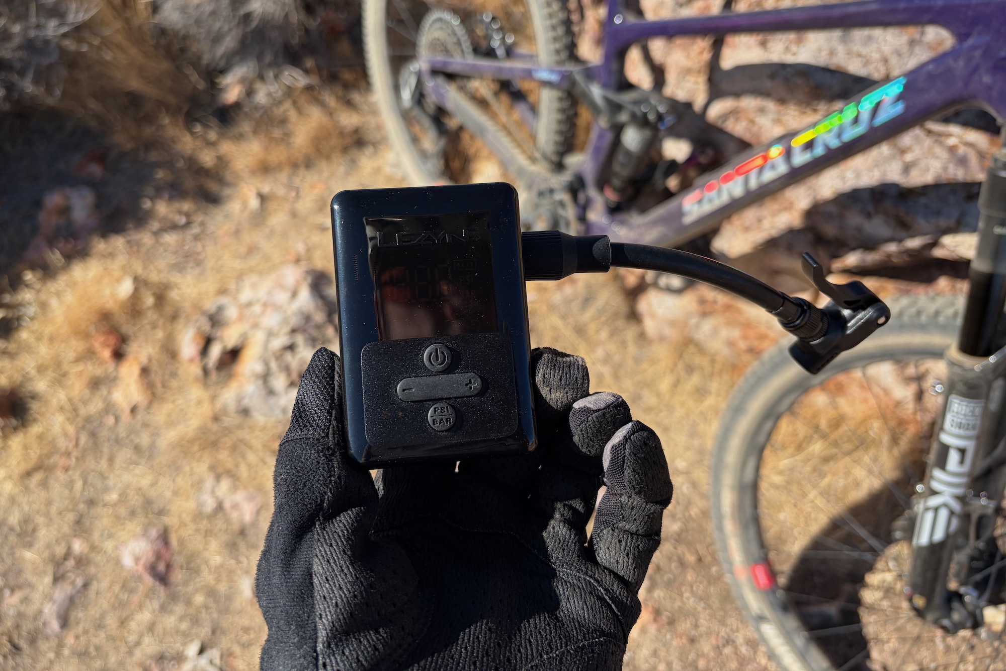 holding the Lezyne E-Drive in hand with a bike in the background