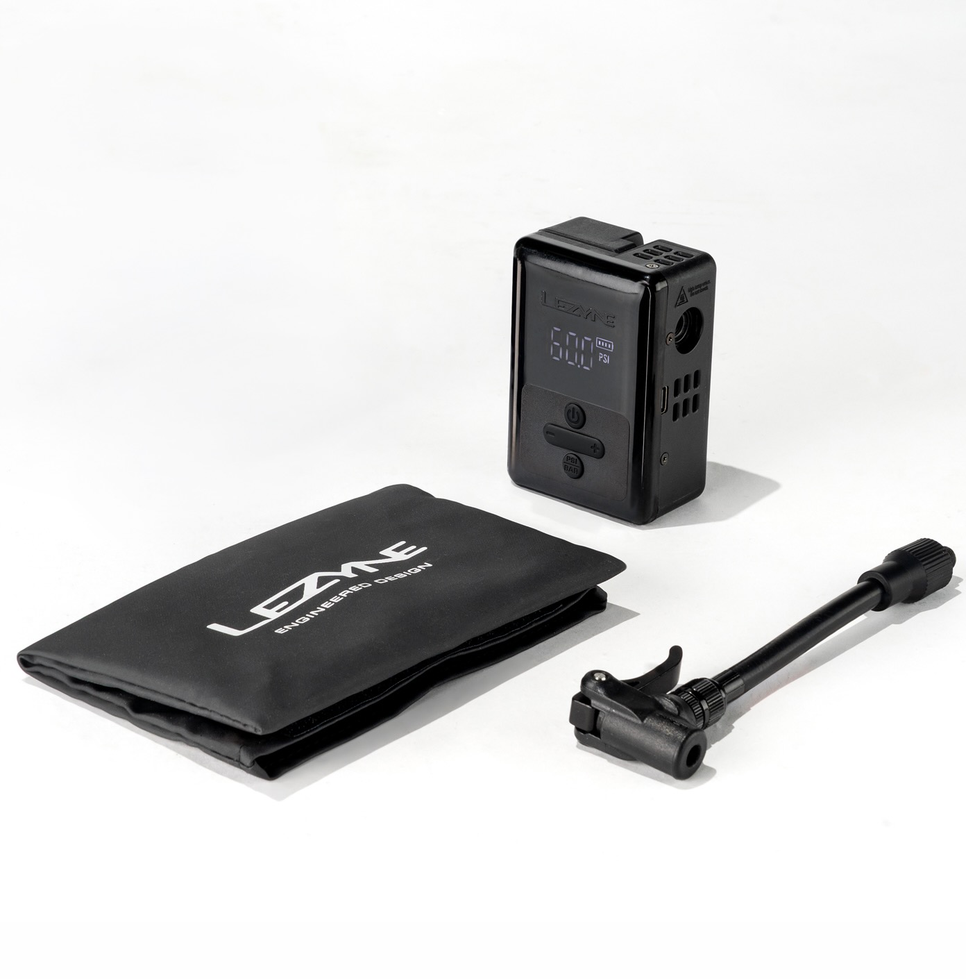 studio image of the lezyne e-drive pump with its storage bag and extension hose.