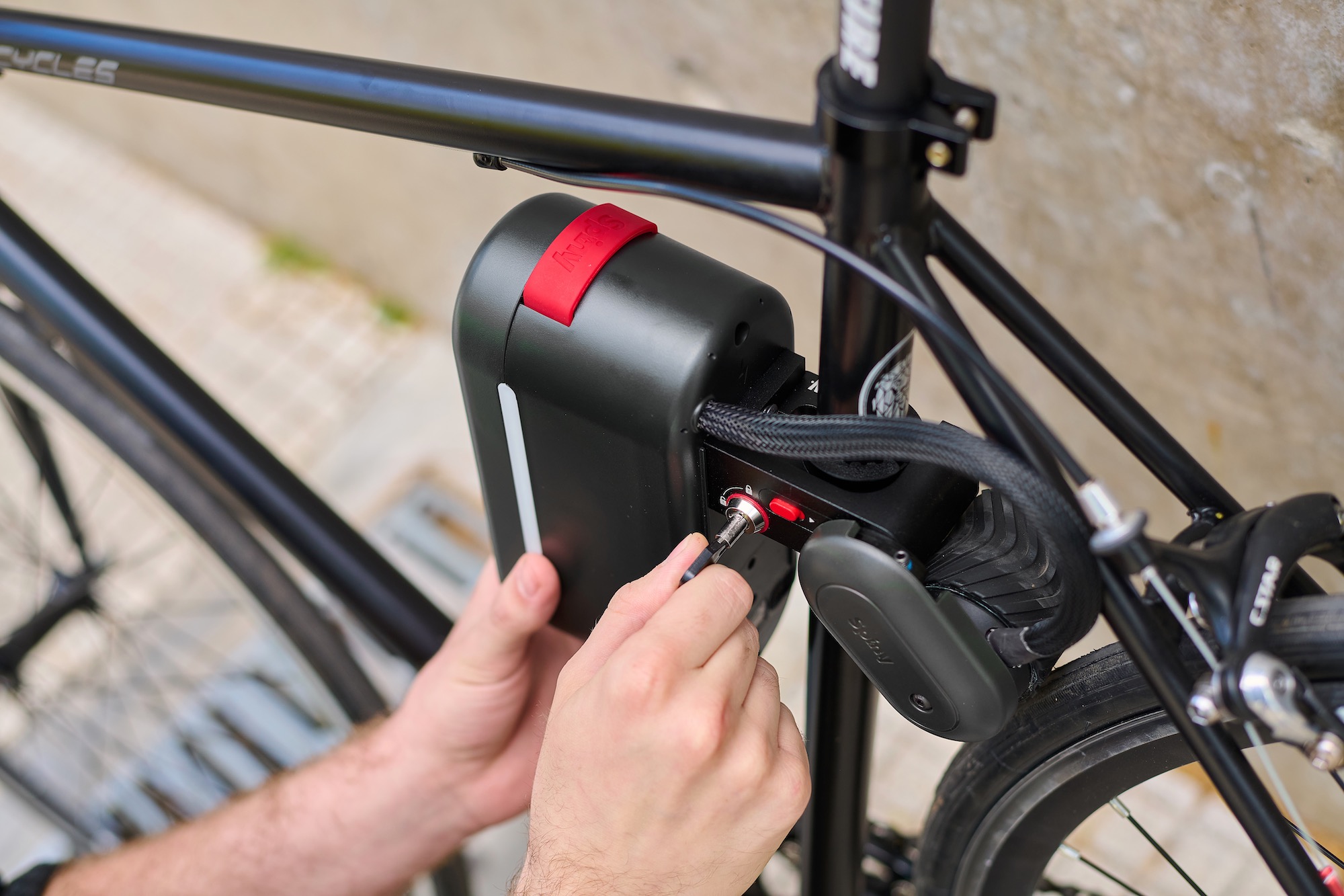 a person unlocking the Spiny 2 from a bike